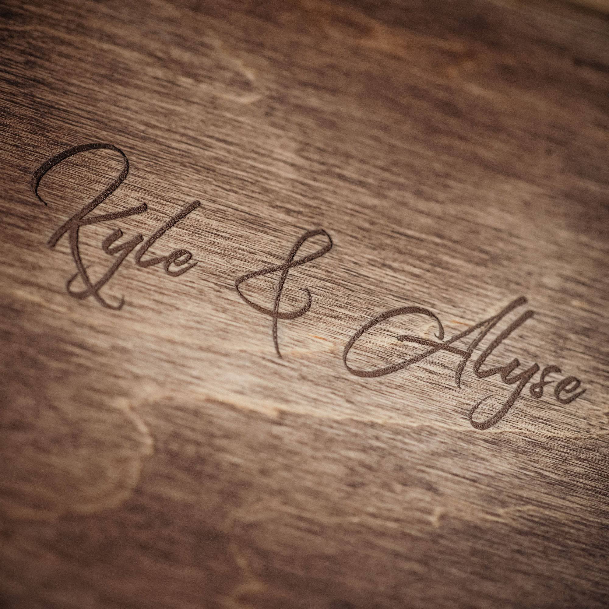 Close up of personalized engraving on vintage style wooden photo box lid