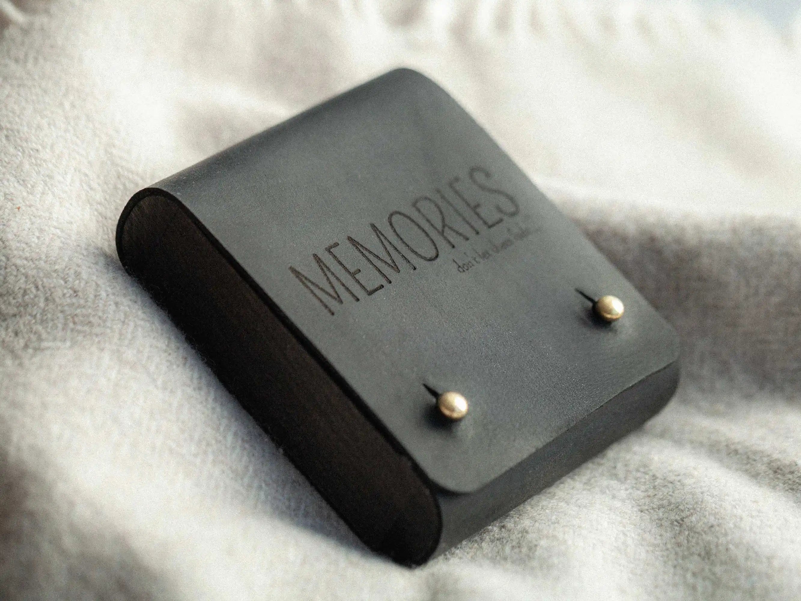 Black Crazy Horse leather USB box, closed top view with brass studs and engraving