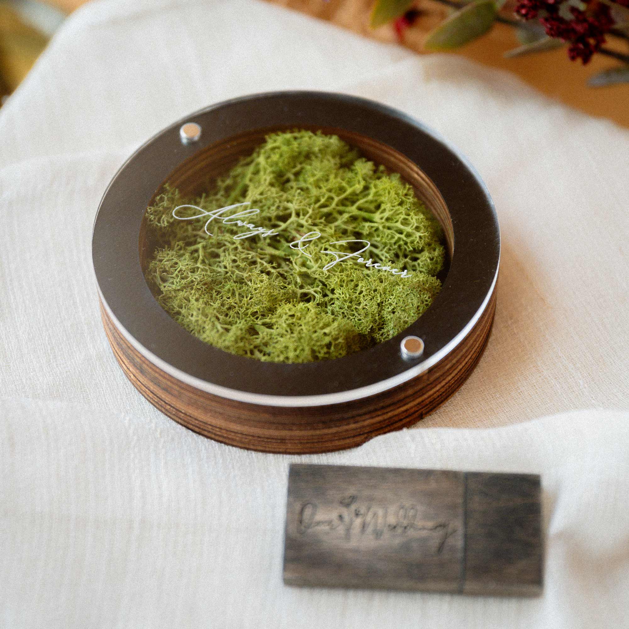 Black USB box with acrylic lid and wooden flash drive beside the box