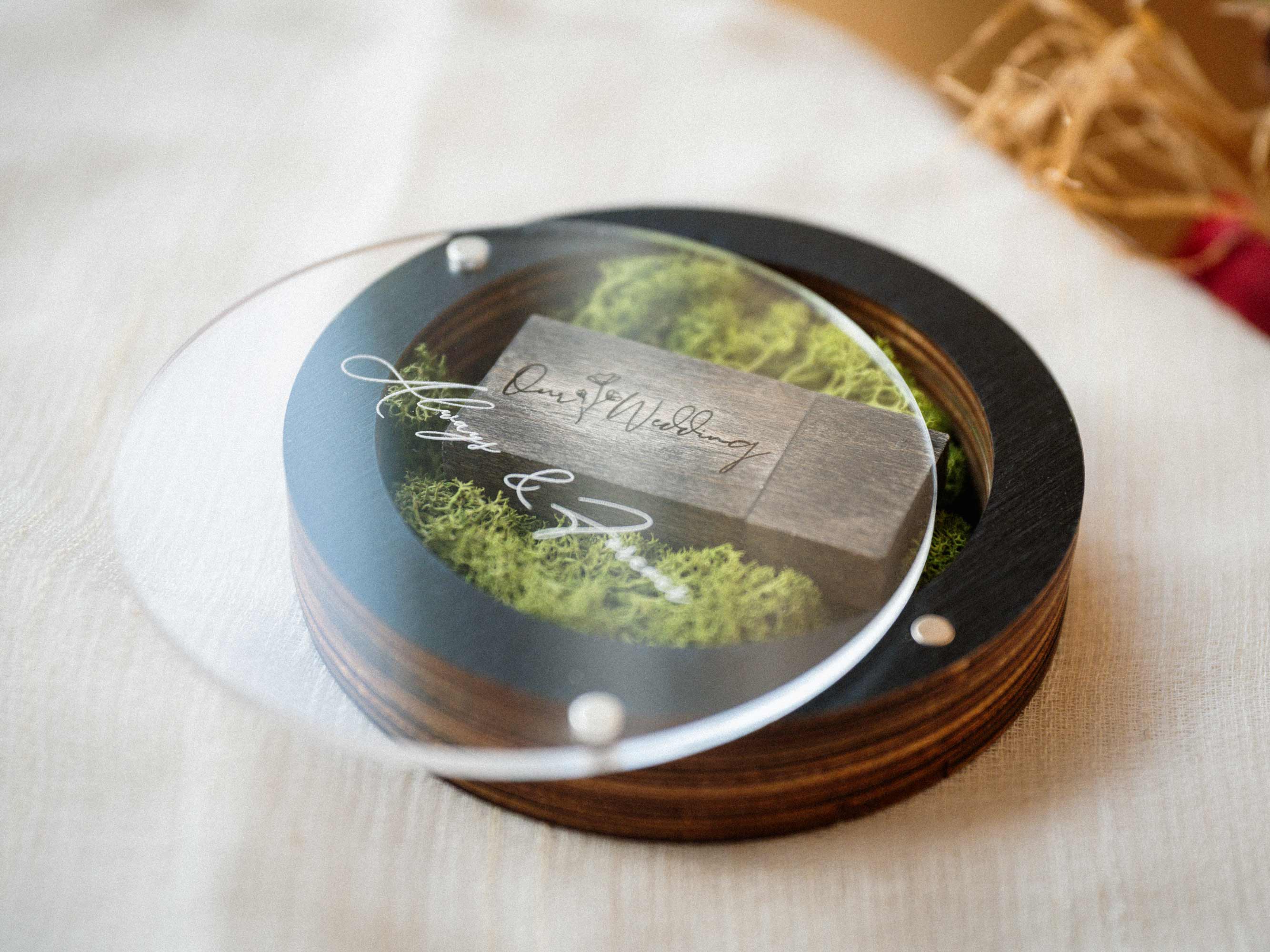Top view of black USB box with acrylic lid and wooden flash drive inside