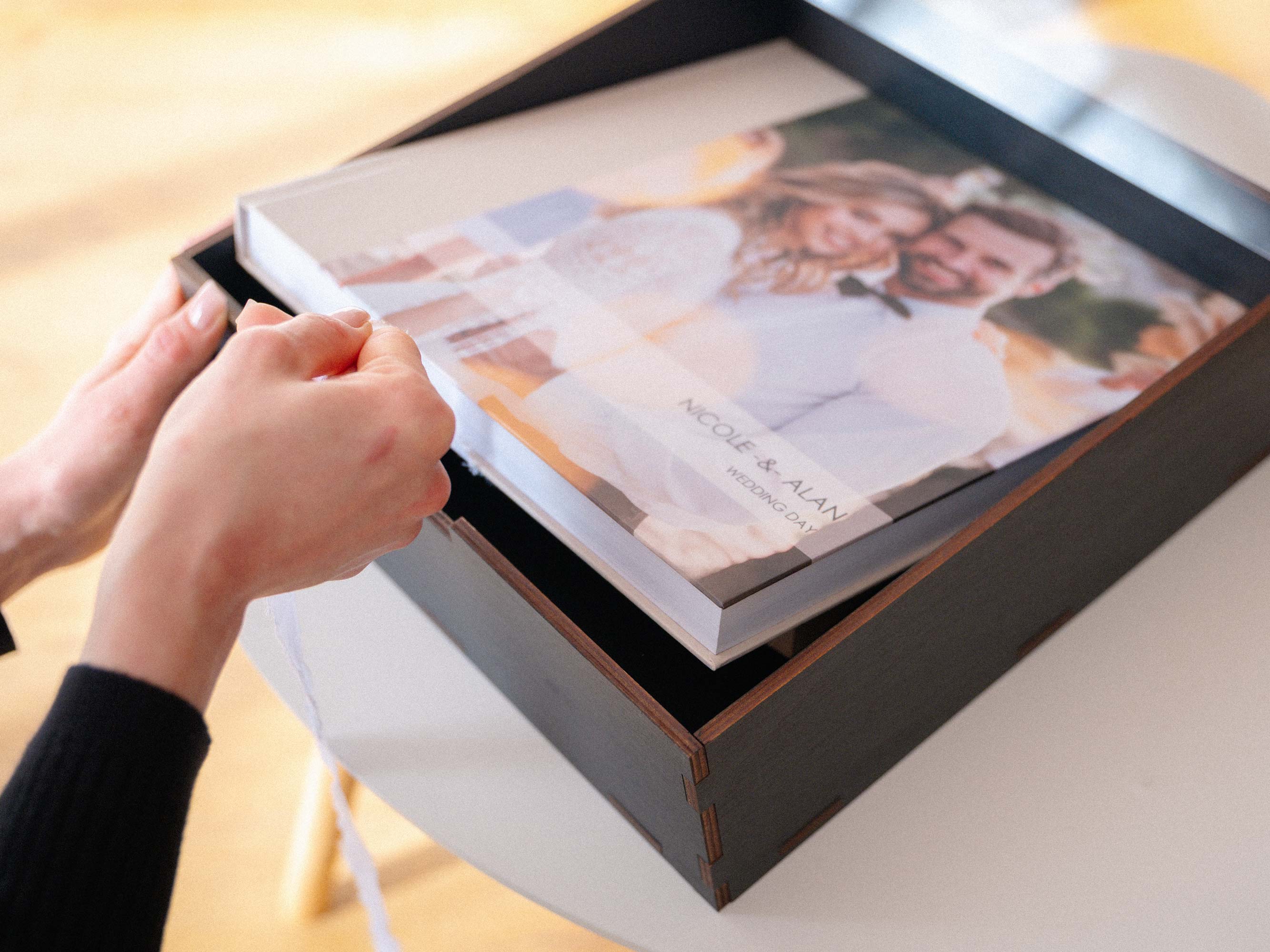 Black wedding album box with acrylic lid and ribbon pull, personalized keepsake box for protecting and presenting printed memories