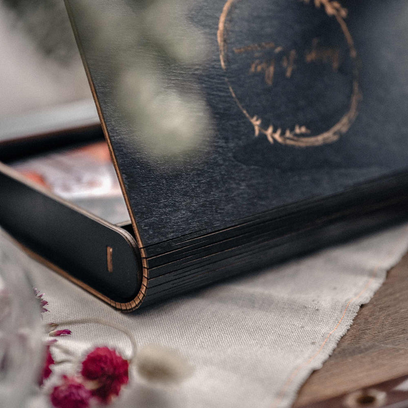 Black wooden photo box with personalized design for wedding photographers, holding up to 100 prints
