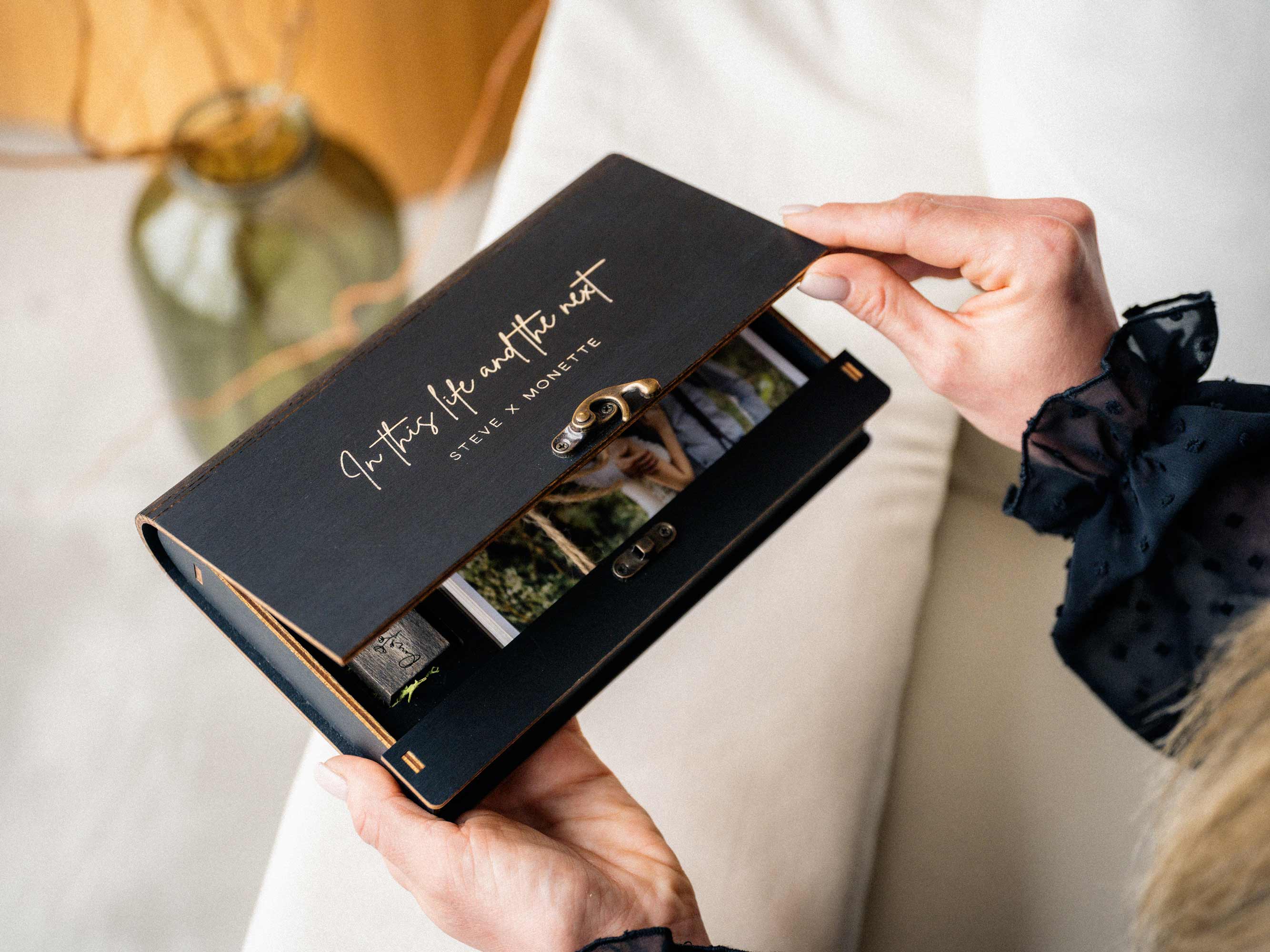 Black wooden photo box with USB drive and wedding prints for client presentation
