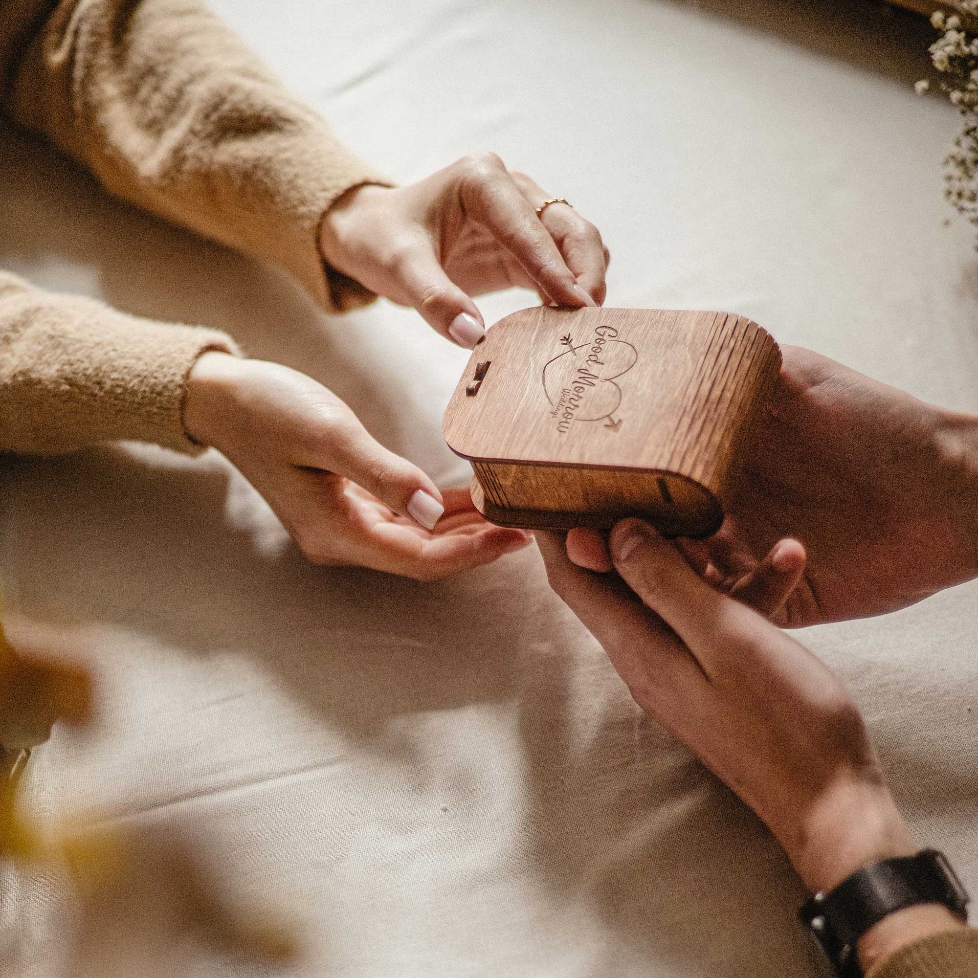 Open teak wooden box with glass jar USB and bright green Scandinavian moss
