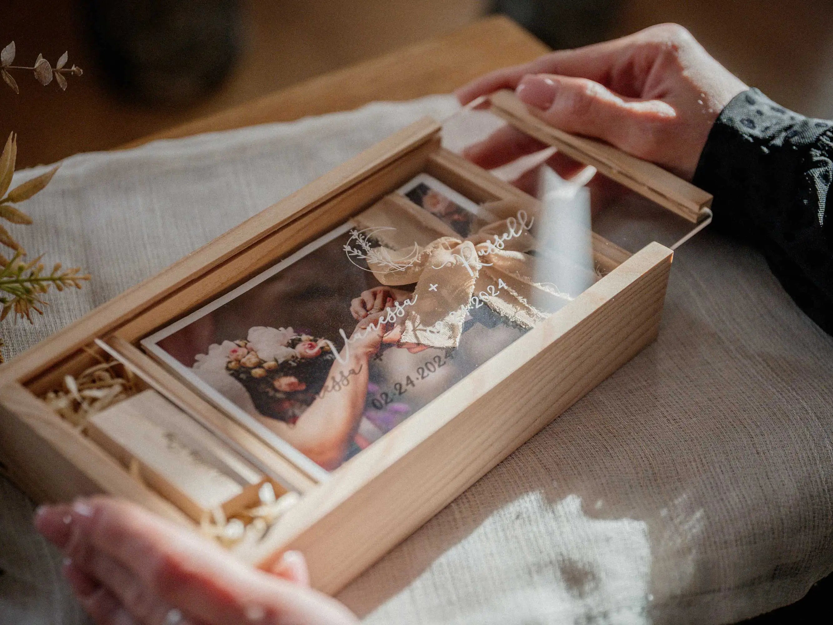 Hands opening personalized maple wooden photo box