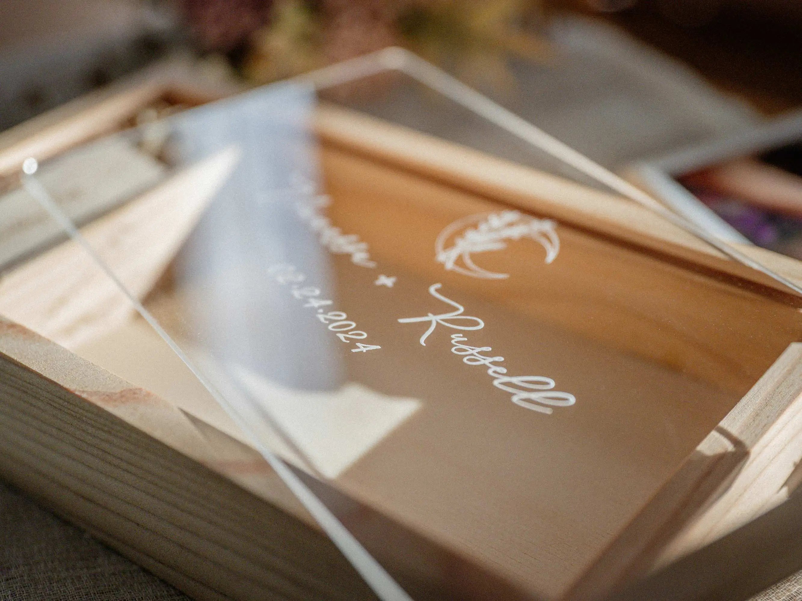 Close-up of personalized acrylic lid on maple wooden photo box