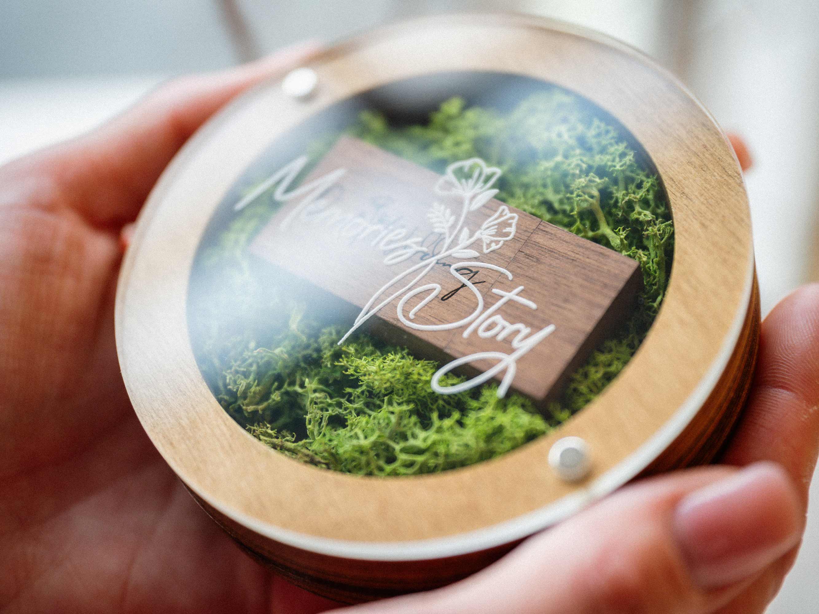 Gold Oak USB box shown in hands with acrylic lid and wooden flash drive inside