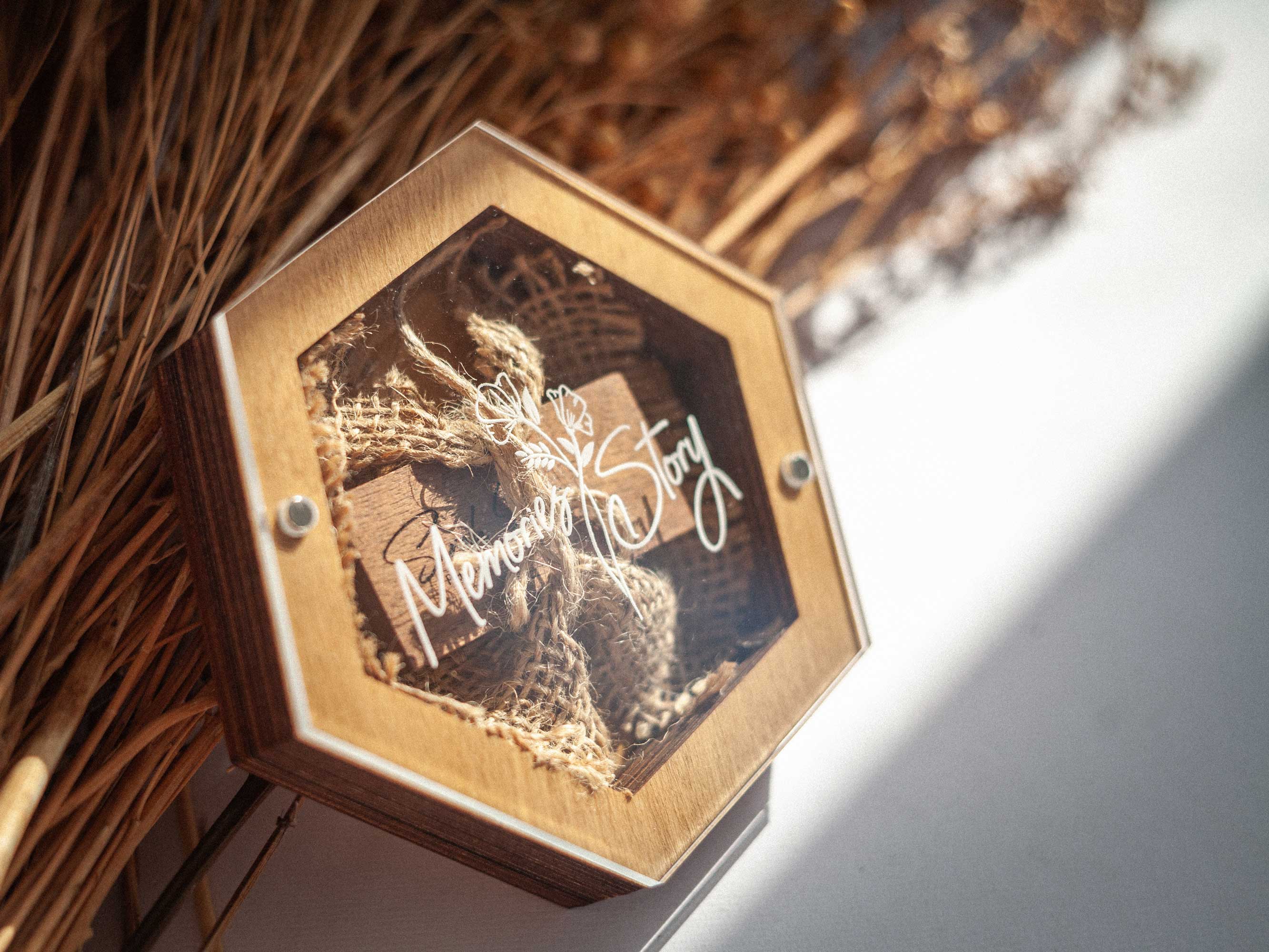 Gold Oak hexagon wedding USB box with personalized acrylic lid on dried grass