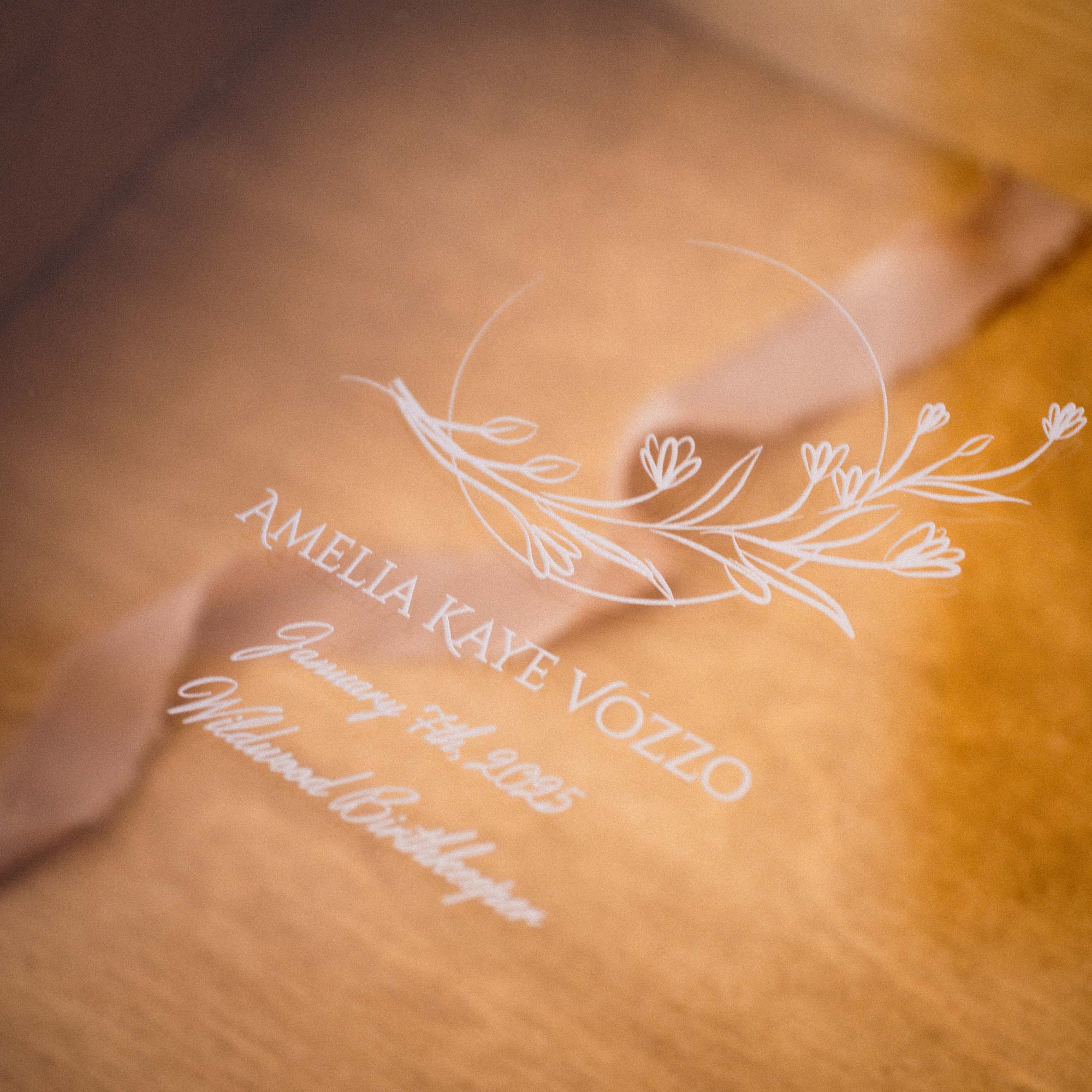 Close-up of engraved personalized lid on Gold Oak wooden album box with acrylic cover