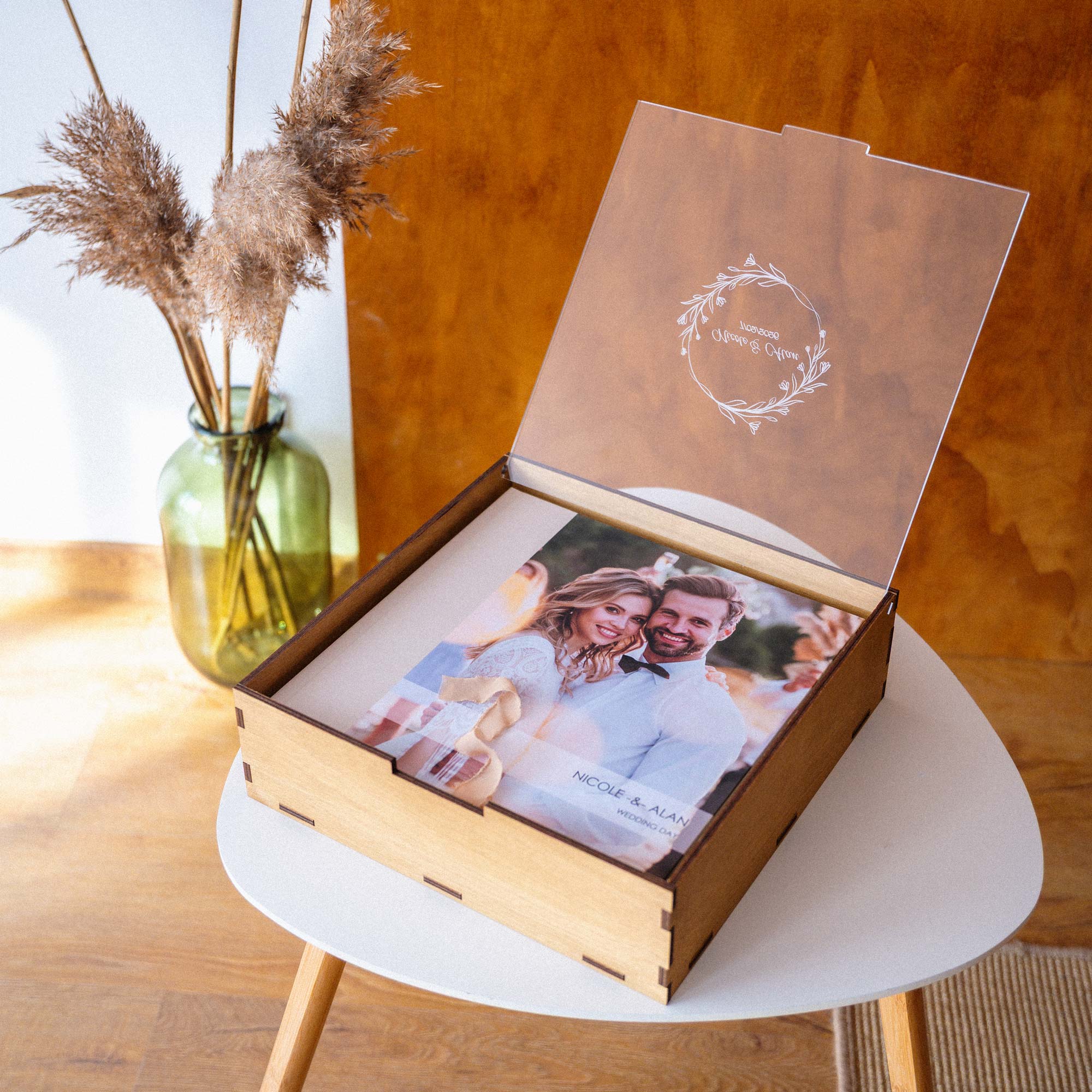 Personalized Gold Oak wedding album box with acrylic lid on table with printed photo album