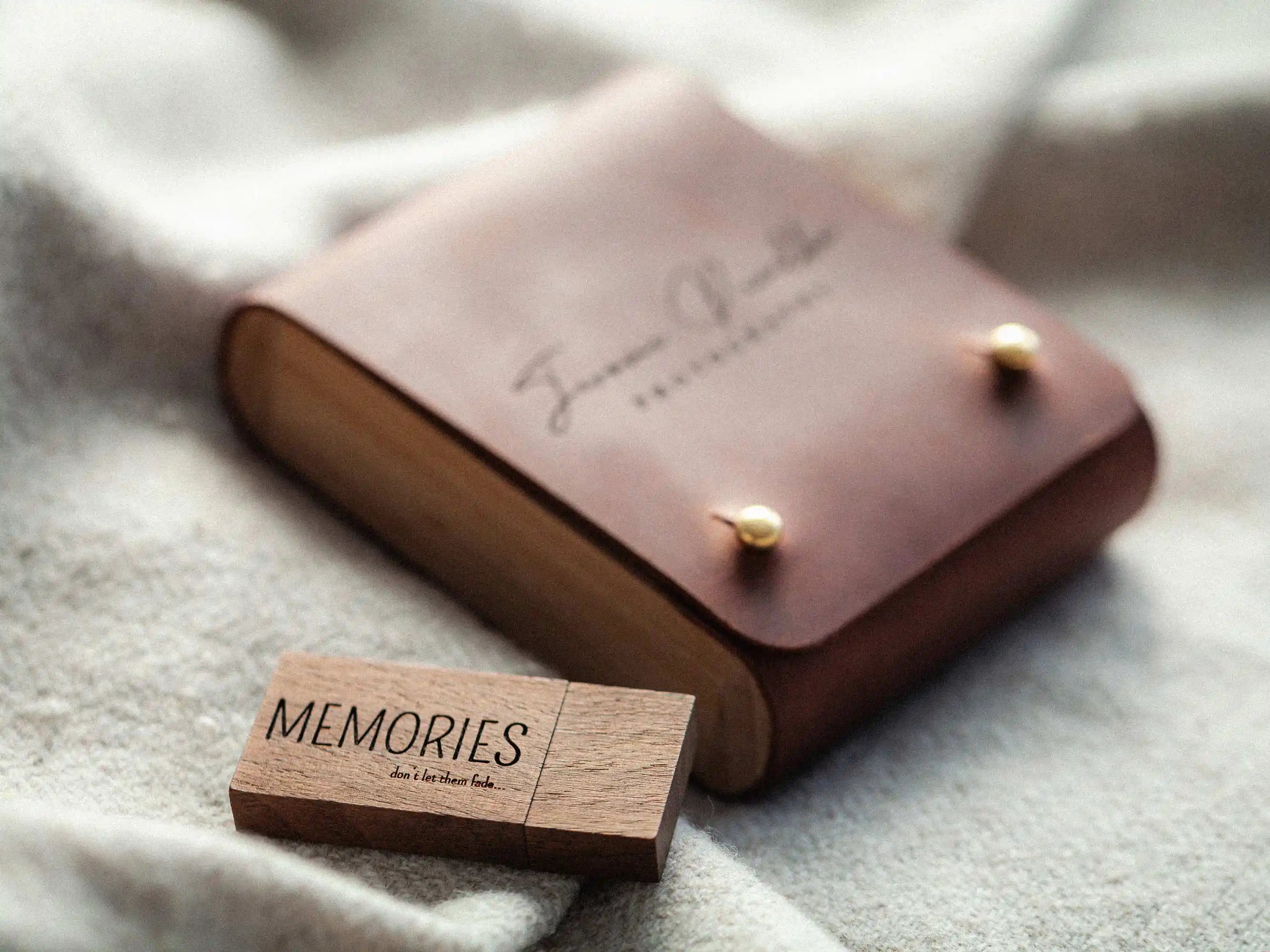Cognac leather USB box with wooden “MEMORIES” USB drive, lifestyle on blanket