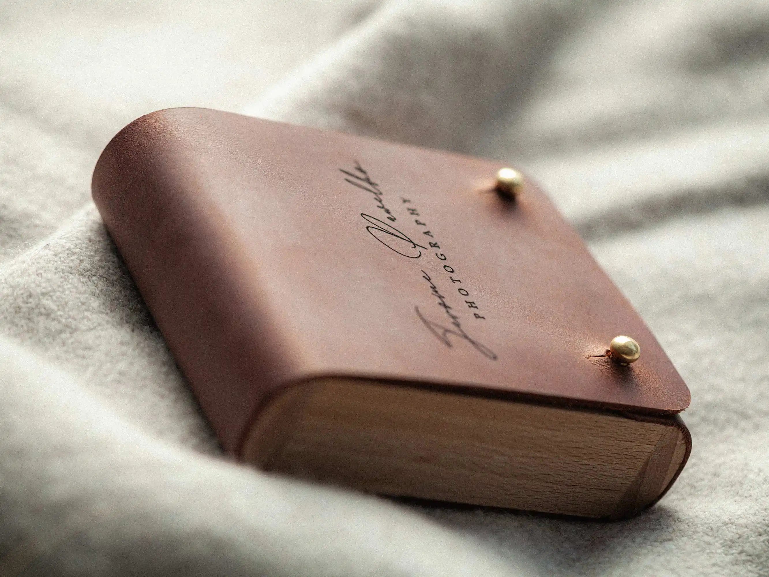 Side view of closed leather USB box showing wooden body and rounded edges