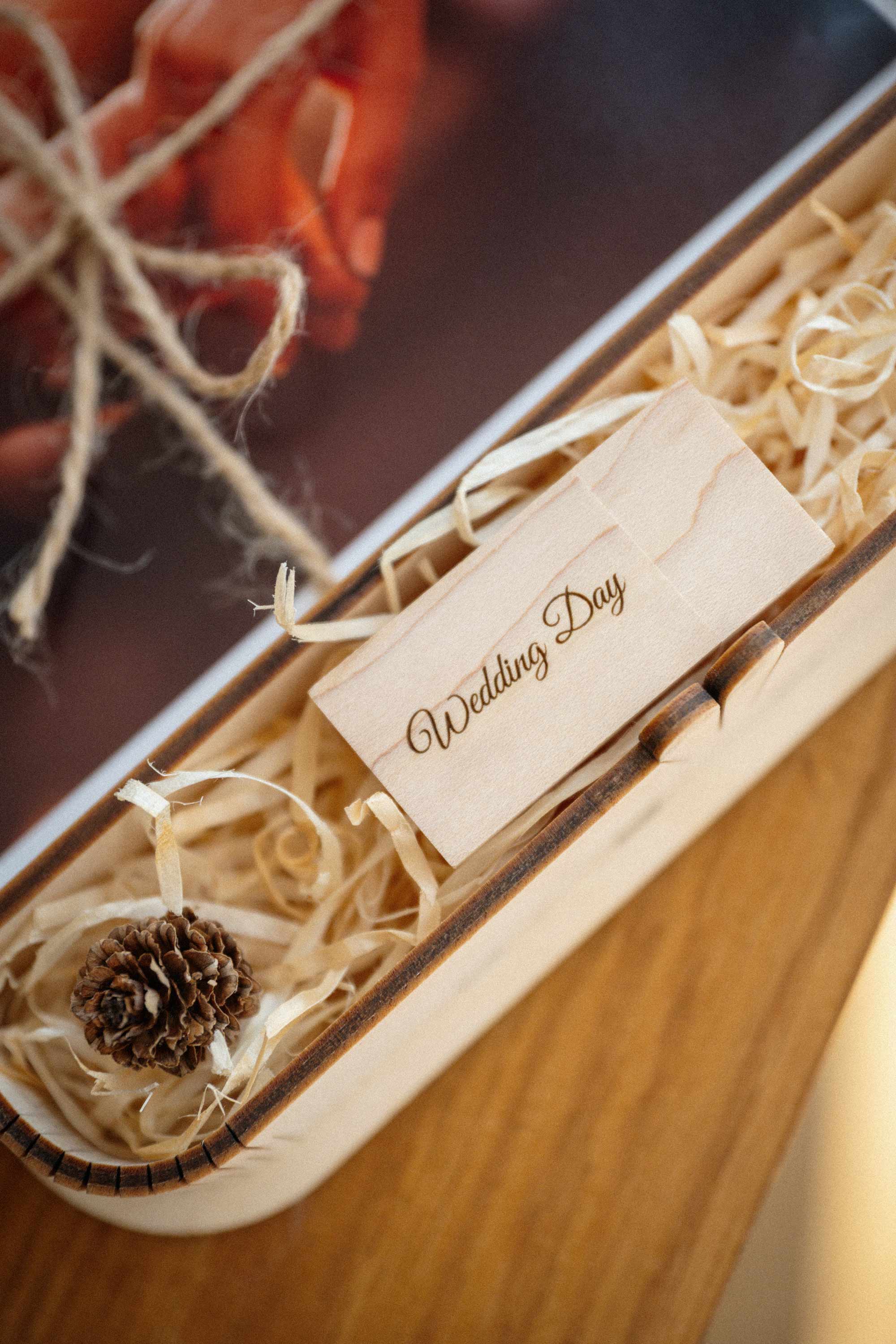Close up of maple wedding photo box USB compartment with engraved wooden flash drive