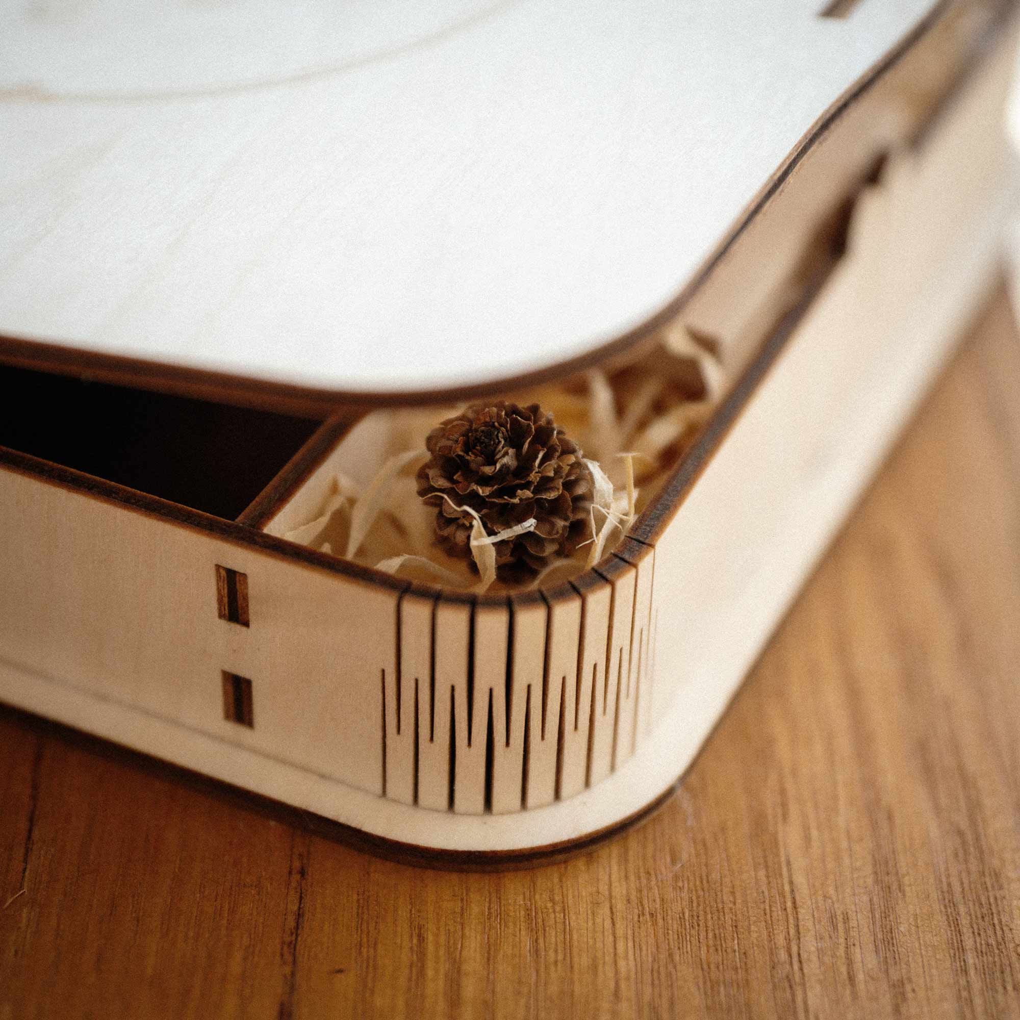 Corner detail of maple wooden photo box with rounded edge and natural wood grain