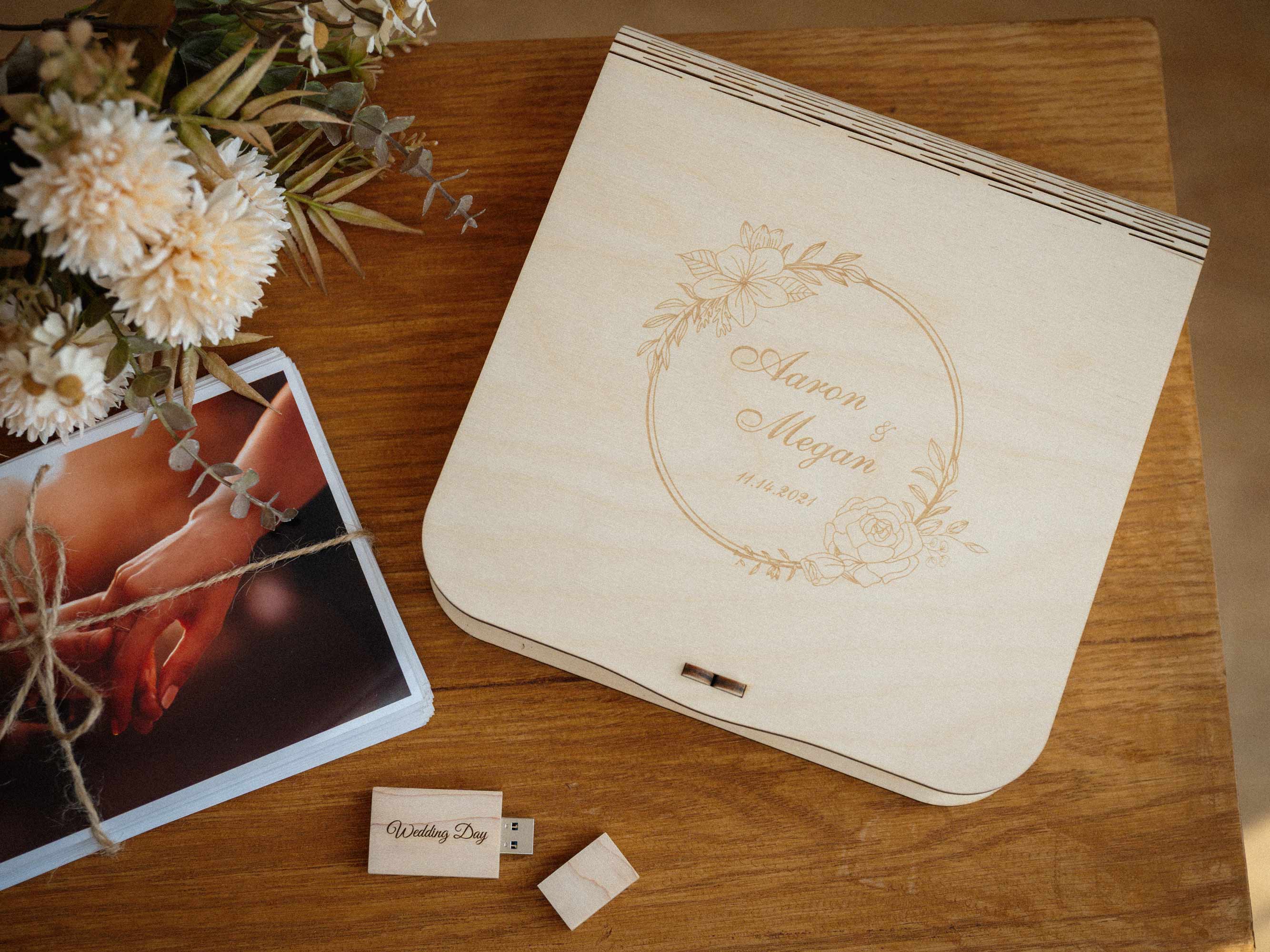 Top view of maple wedding photo box with engraved lid, prints and wooden USB