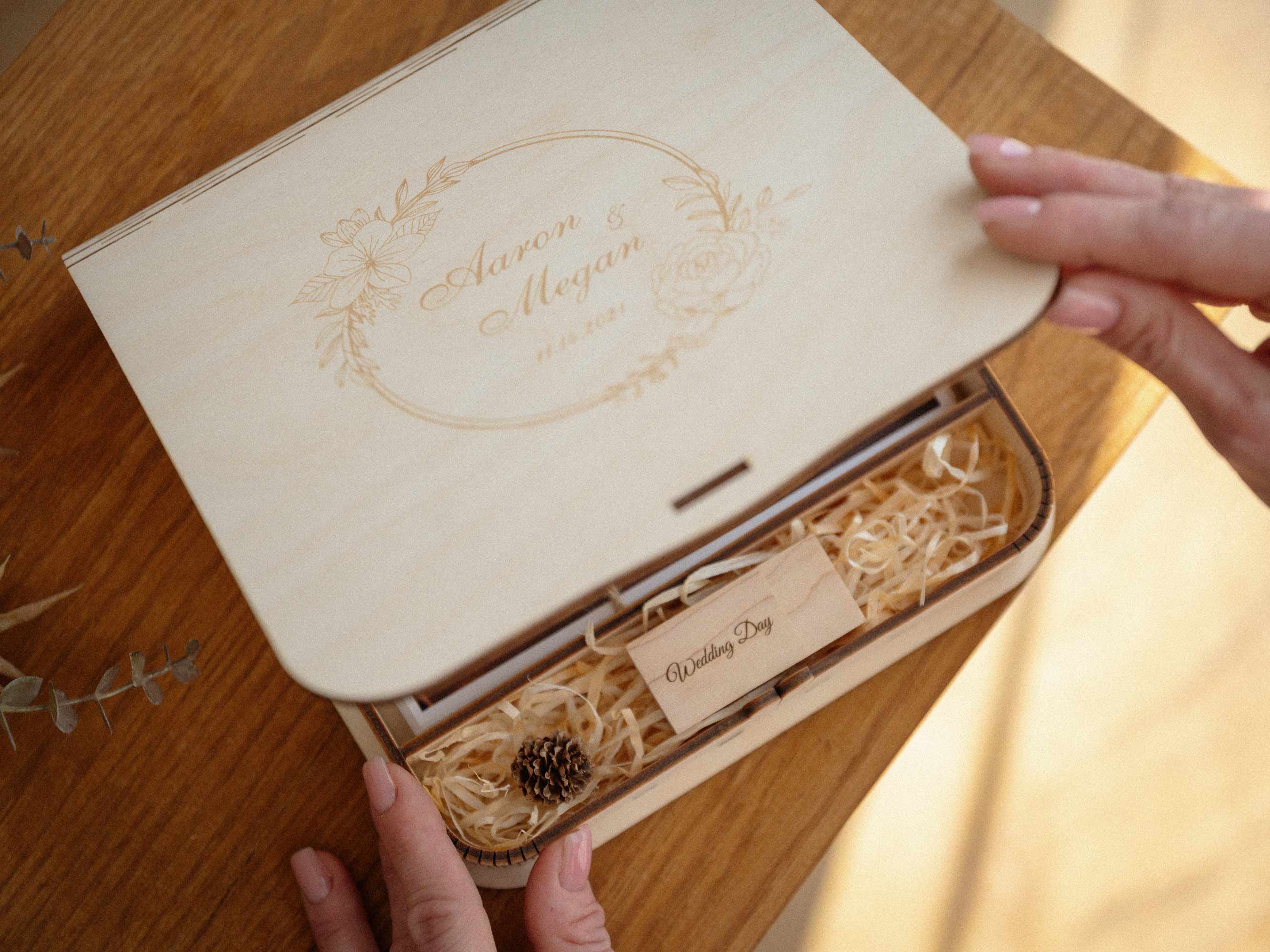 Opening engraved maple wedding photo box with USB and photo prints inside
