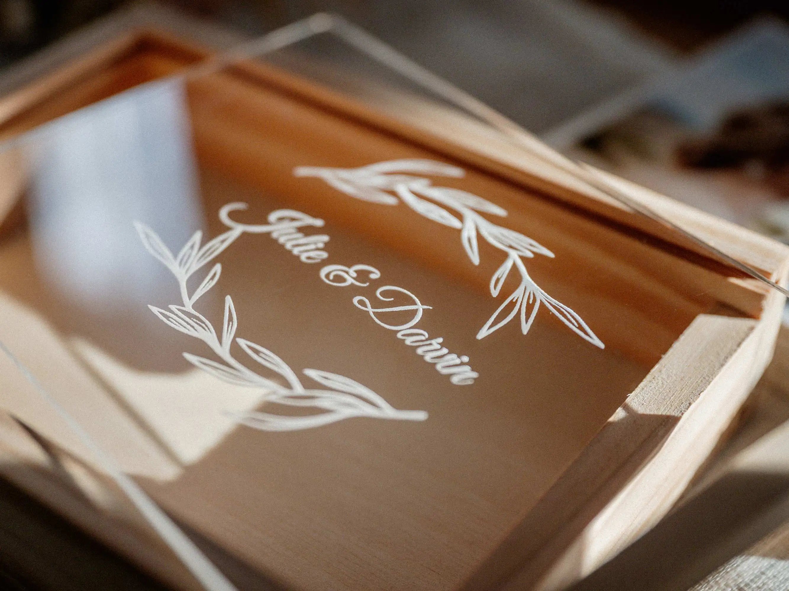 Close-up of personalized acrylic lid on maple wooden photo box