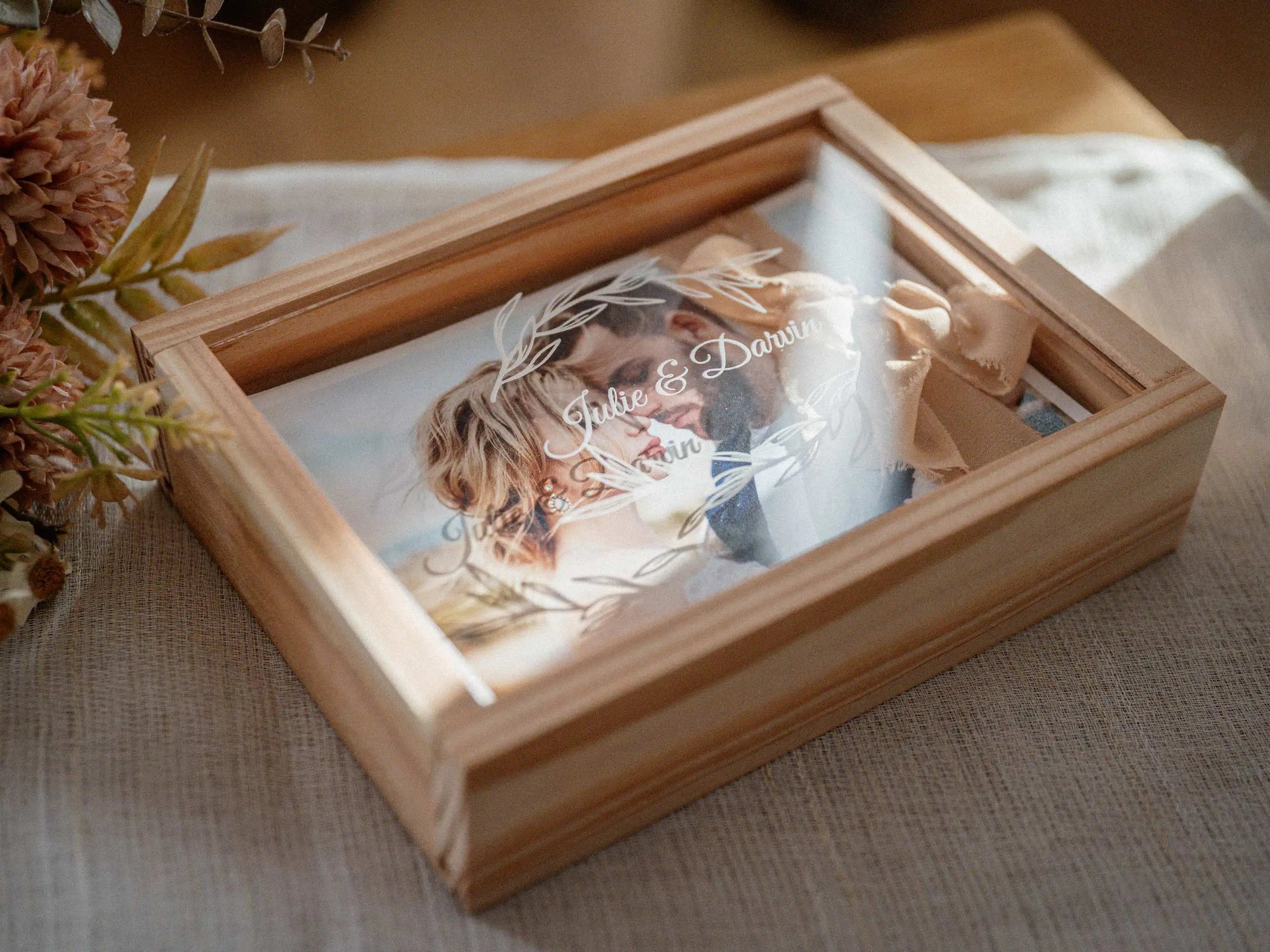 Open maple wooden photo box with prints