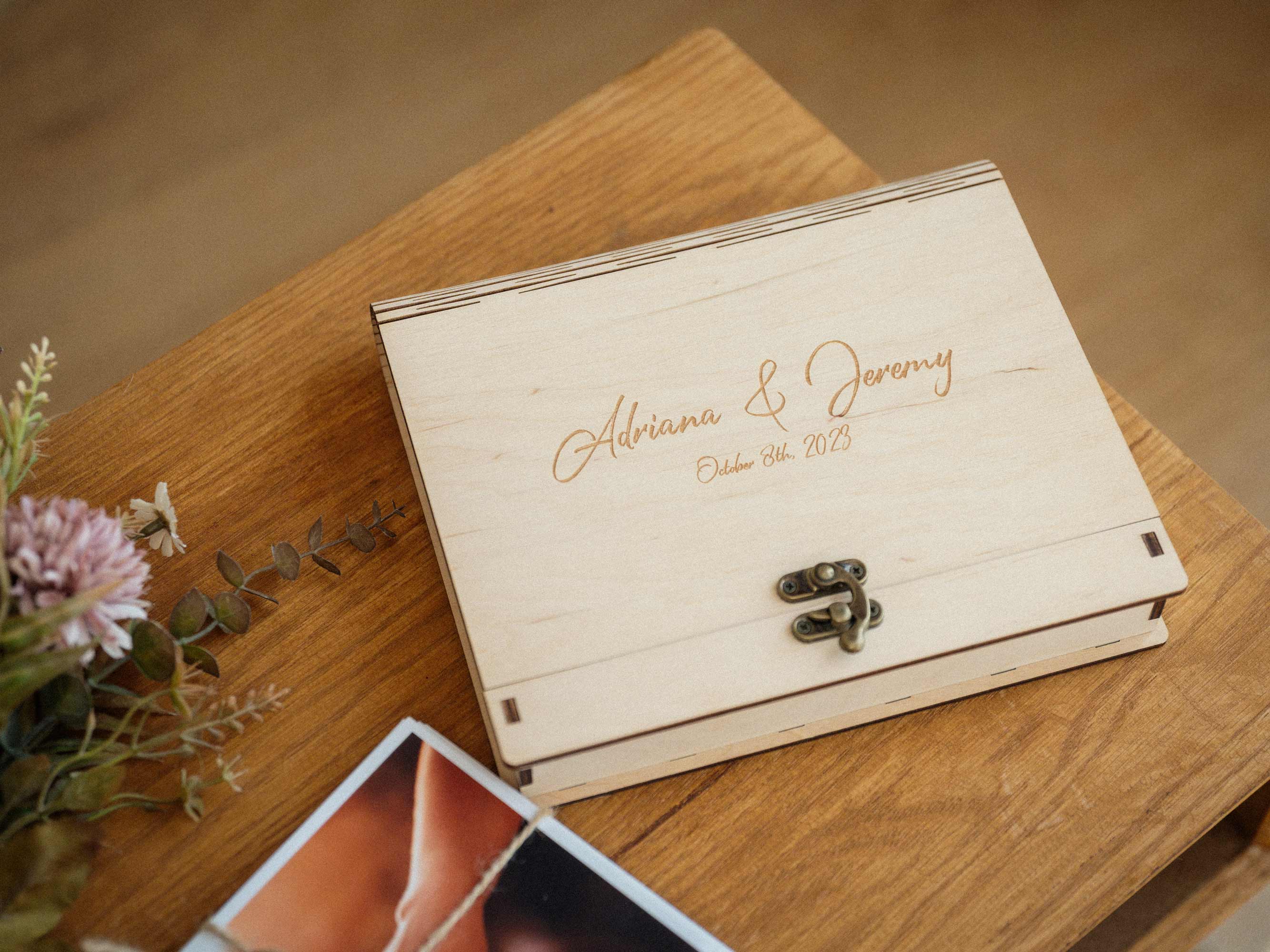 Maple engraved photo box with wedding prints nearby