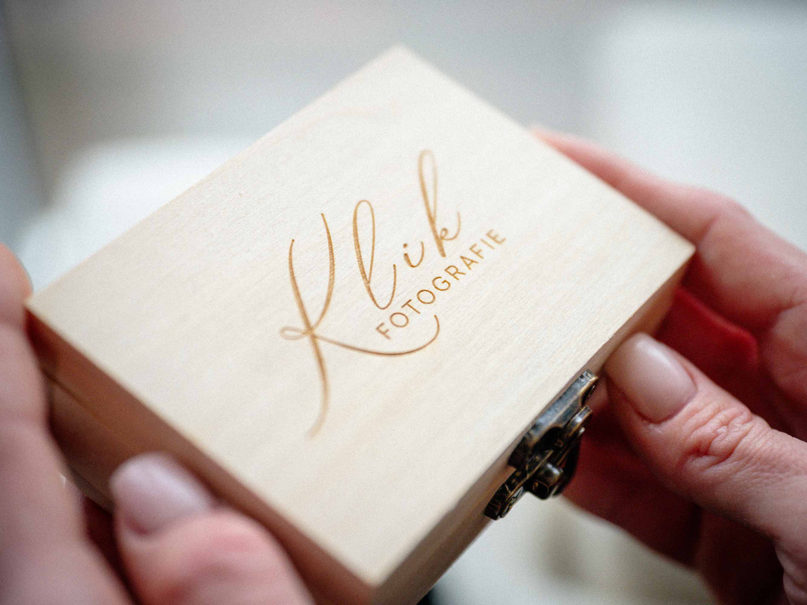Natural wooden USB box with light engraving shown in hands