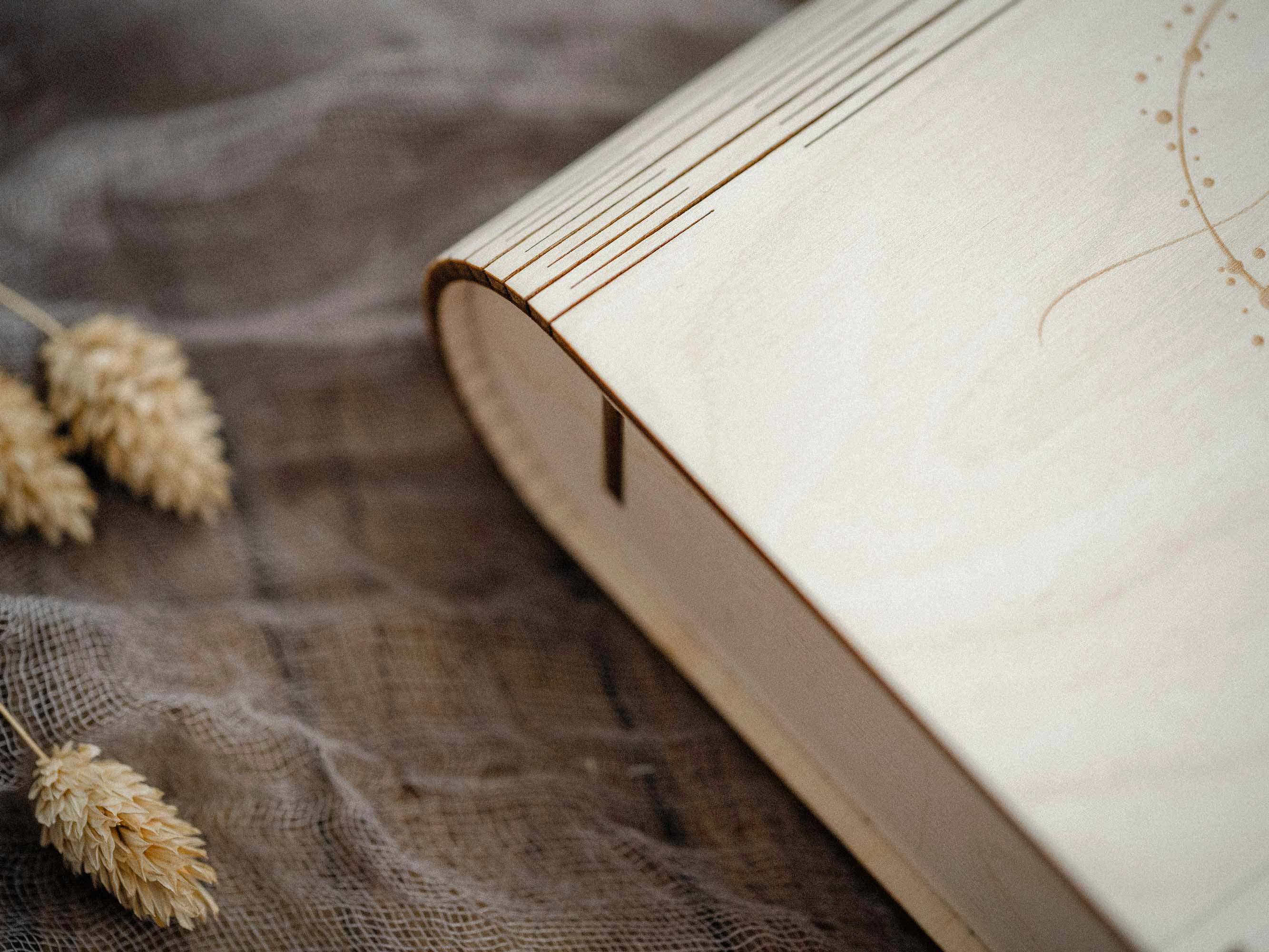 Side view of maple wooden photo box showing rounded spine and clean natural finish