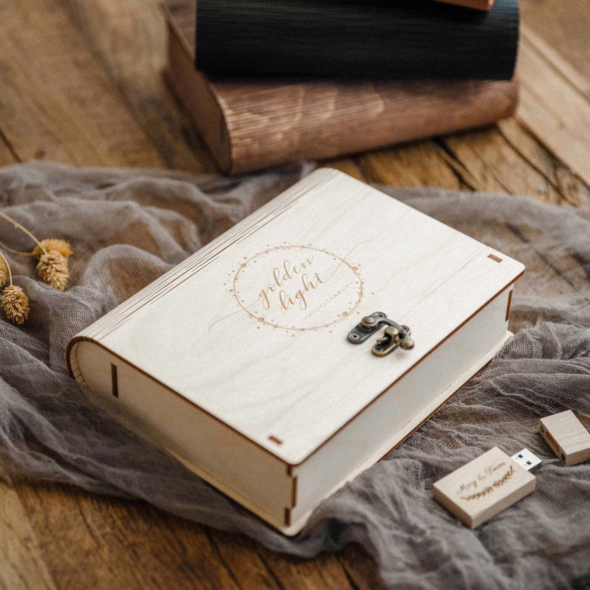 Maple wooden photo box partially open with photos inside, styled on linen fabric