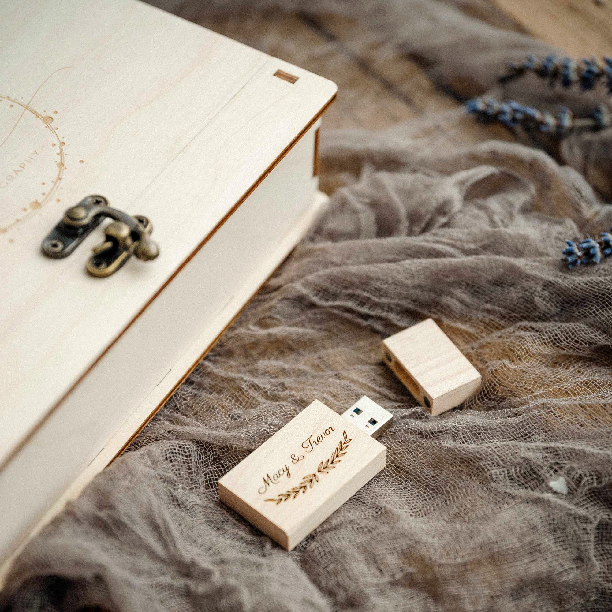Maple engraved photo box top view with matching wooden USB on textured fabric