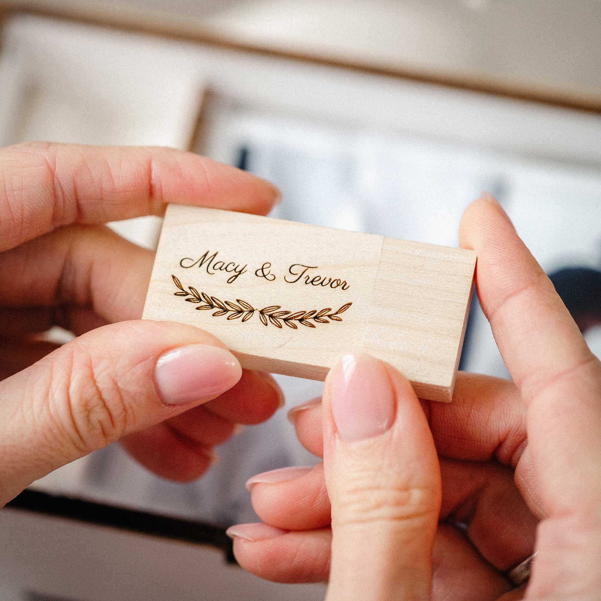 Engraved wooden USB flash drive for photo box with names in hands