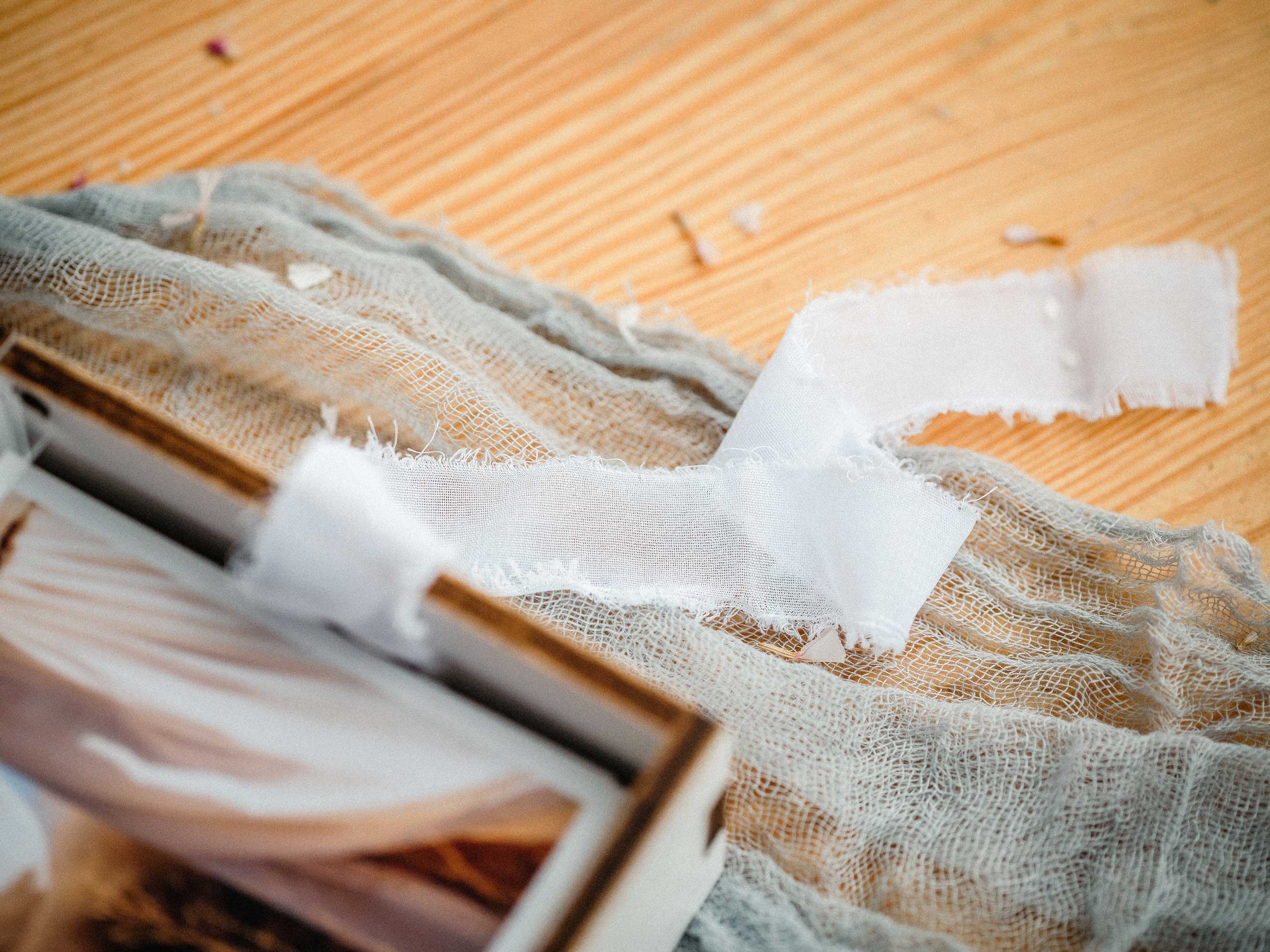 White photo box with USB and acrylic lid styled on wooden surface