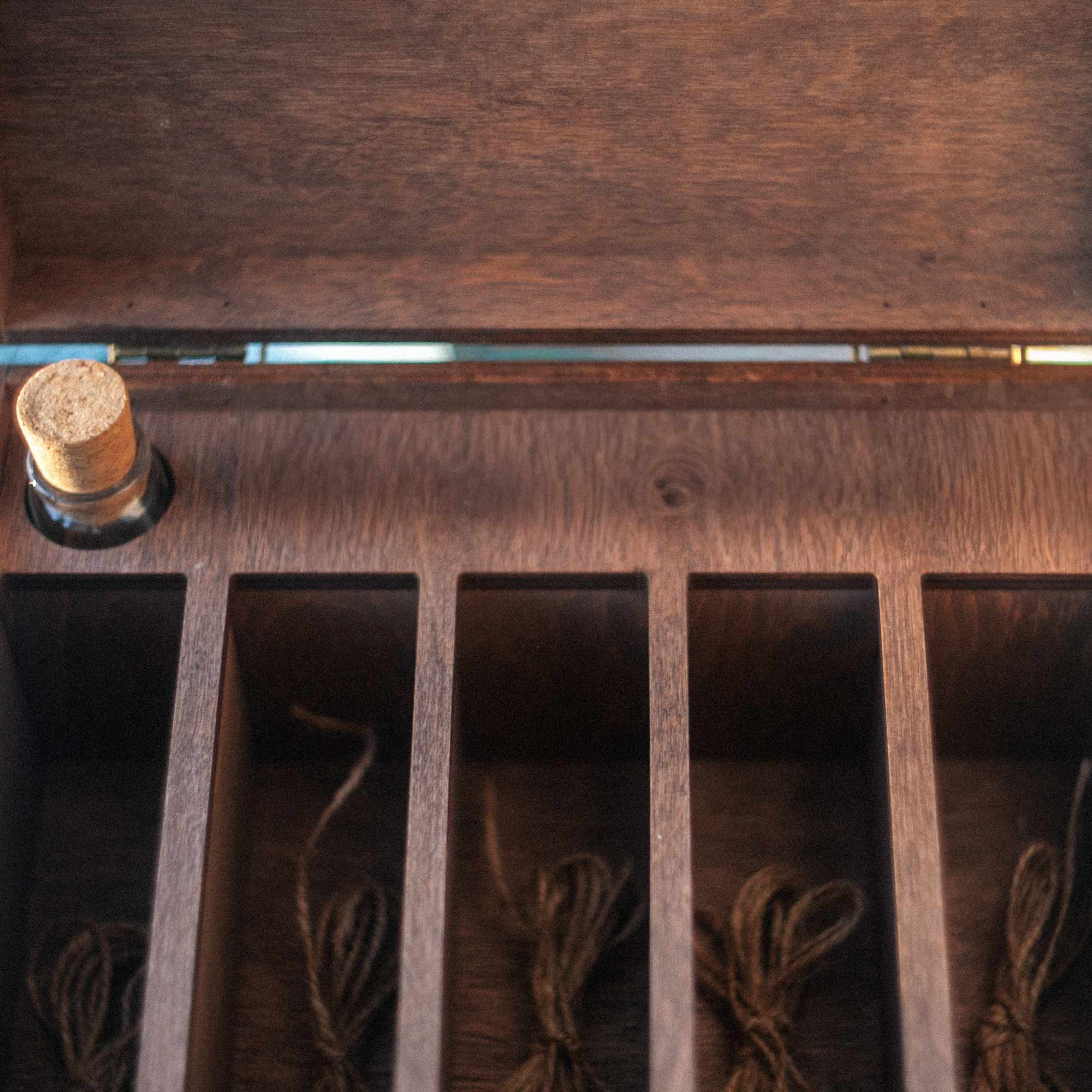 Interior close-up of five photo sections inside wooden family memory box