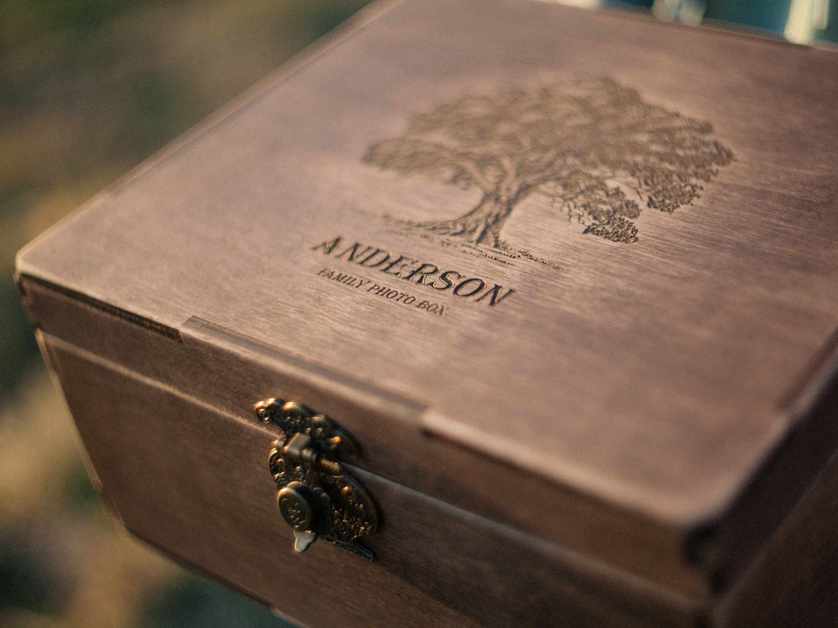 Close-up of personalized wooden family photo box held in hands