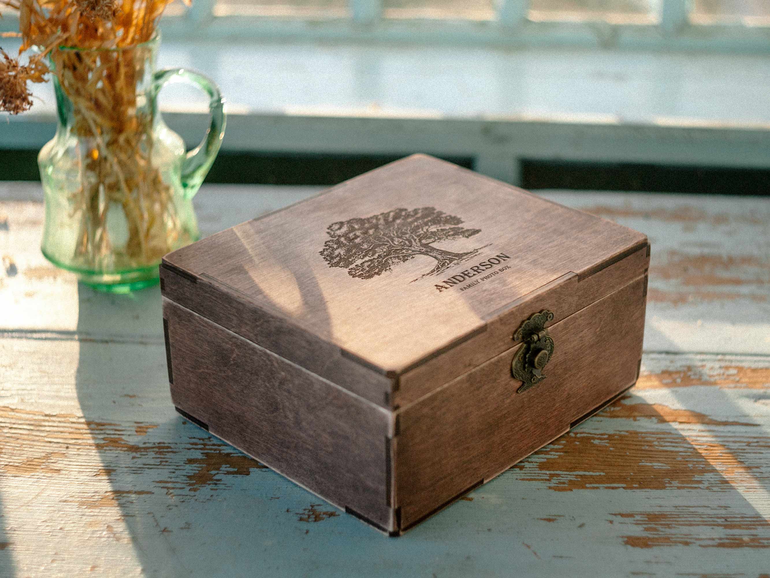 Personalized wooden memory box on vintage table near dried flowers