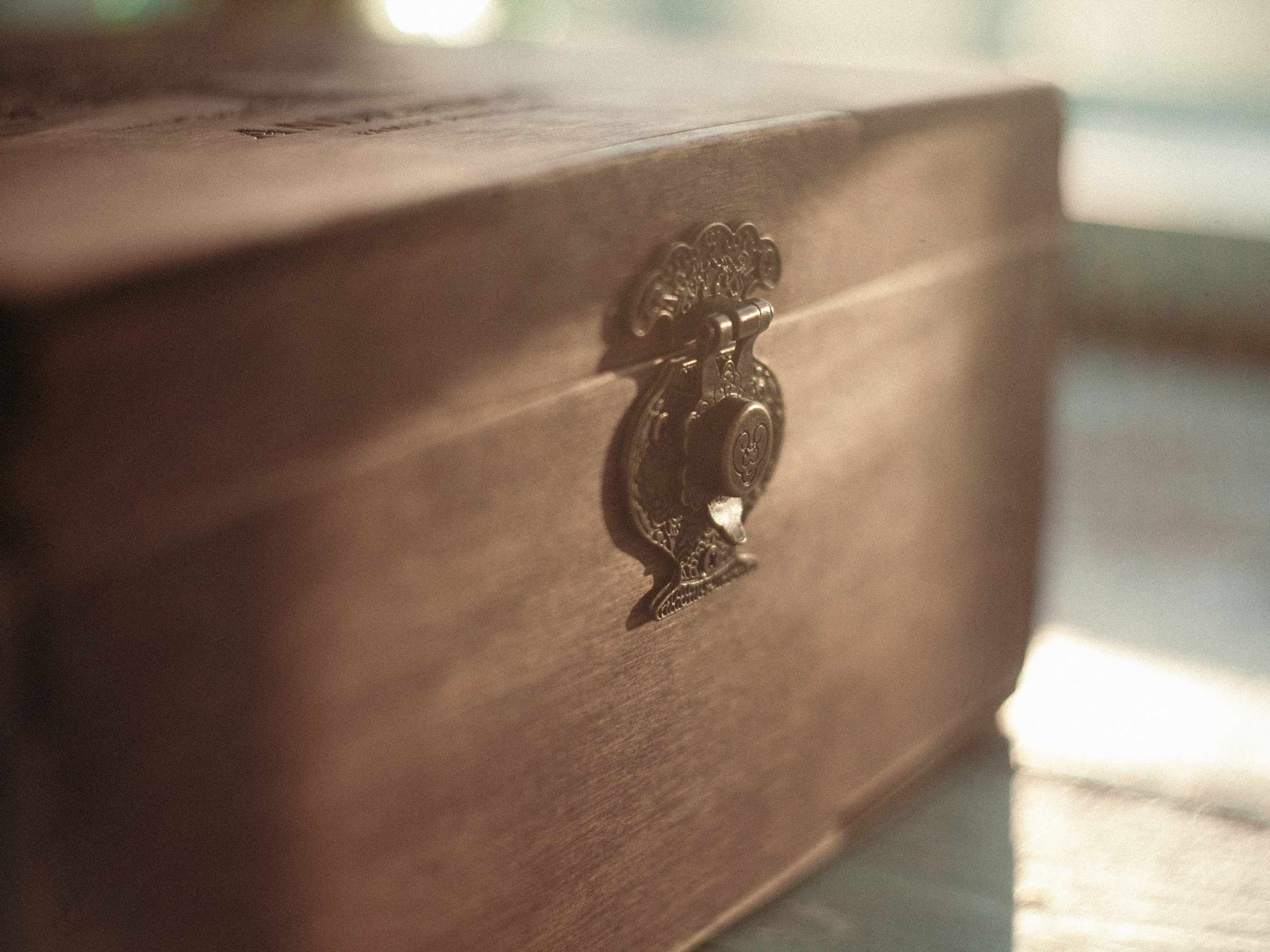 Close-up of decorative clasp on vintage-style wooden photo box