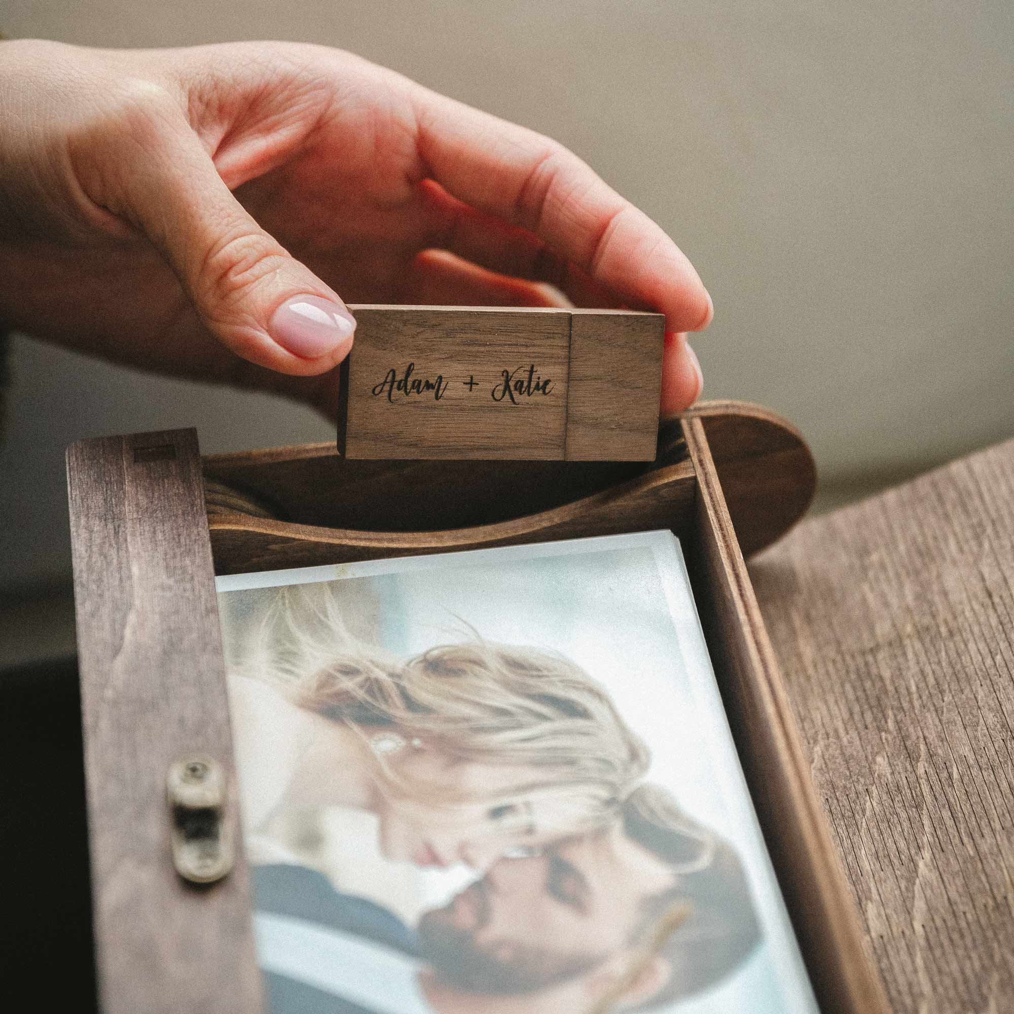 Hand opening walnut photo box showing photos and twine inside