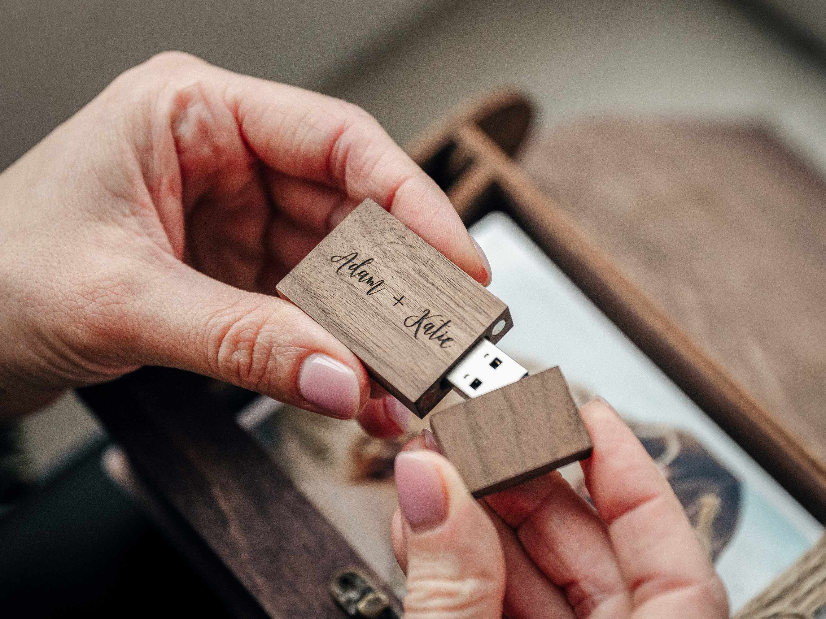 Woman holding closed walnut classic wooden photo box with engraved lid