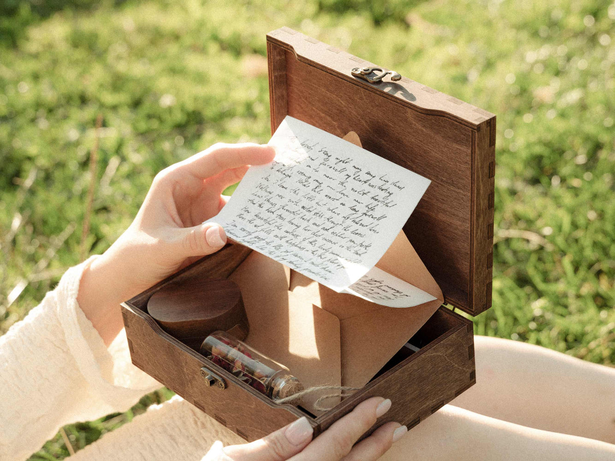 Open personalized keepsake box holding a handwritten wedding letter