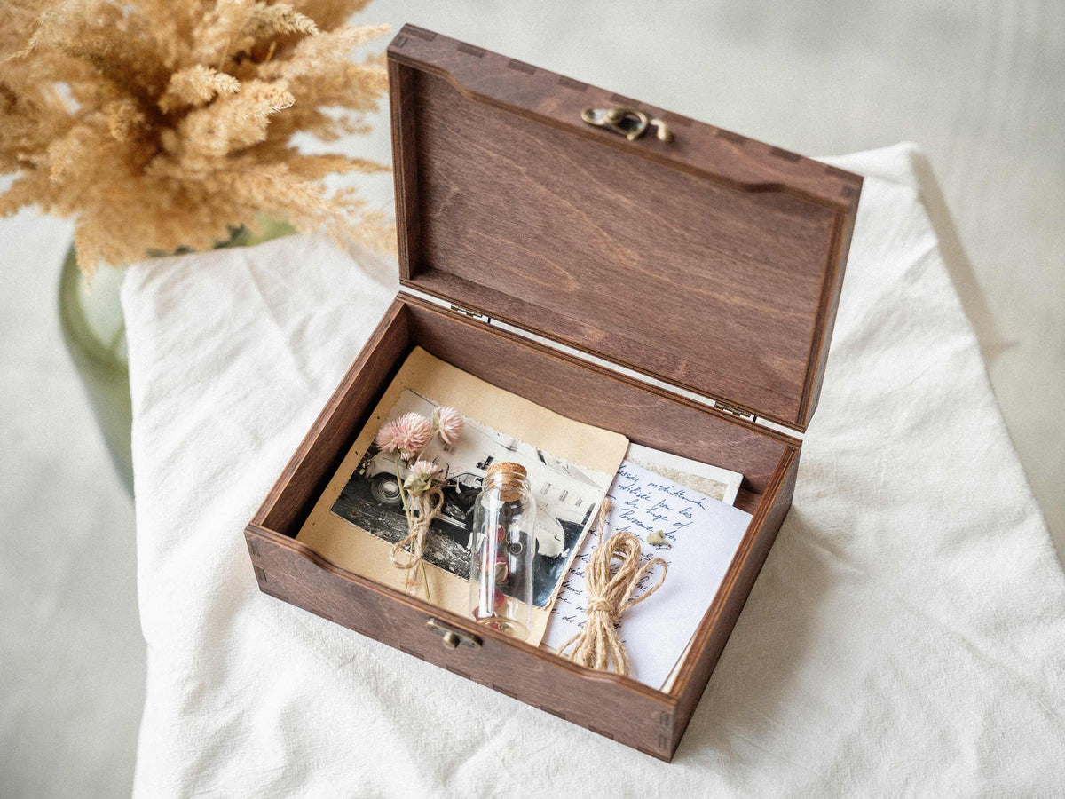 Open wedding keepsake box with photographs and dried flowers