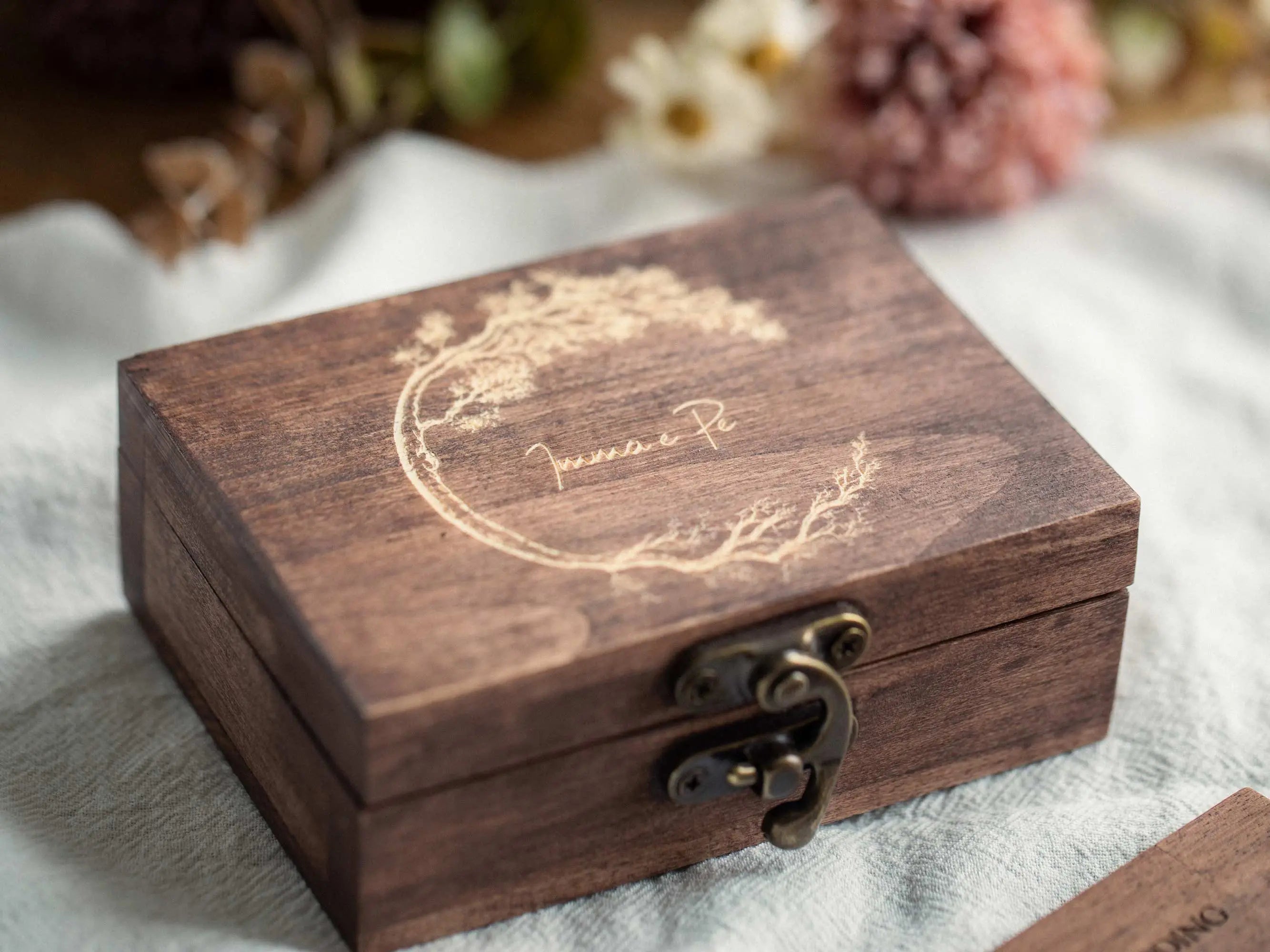 Closed engraved wooden USB box with metal clasp, rustic keepsake photo packaging.