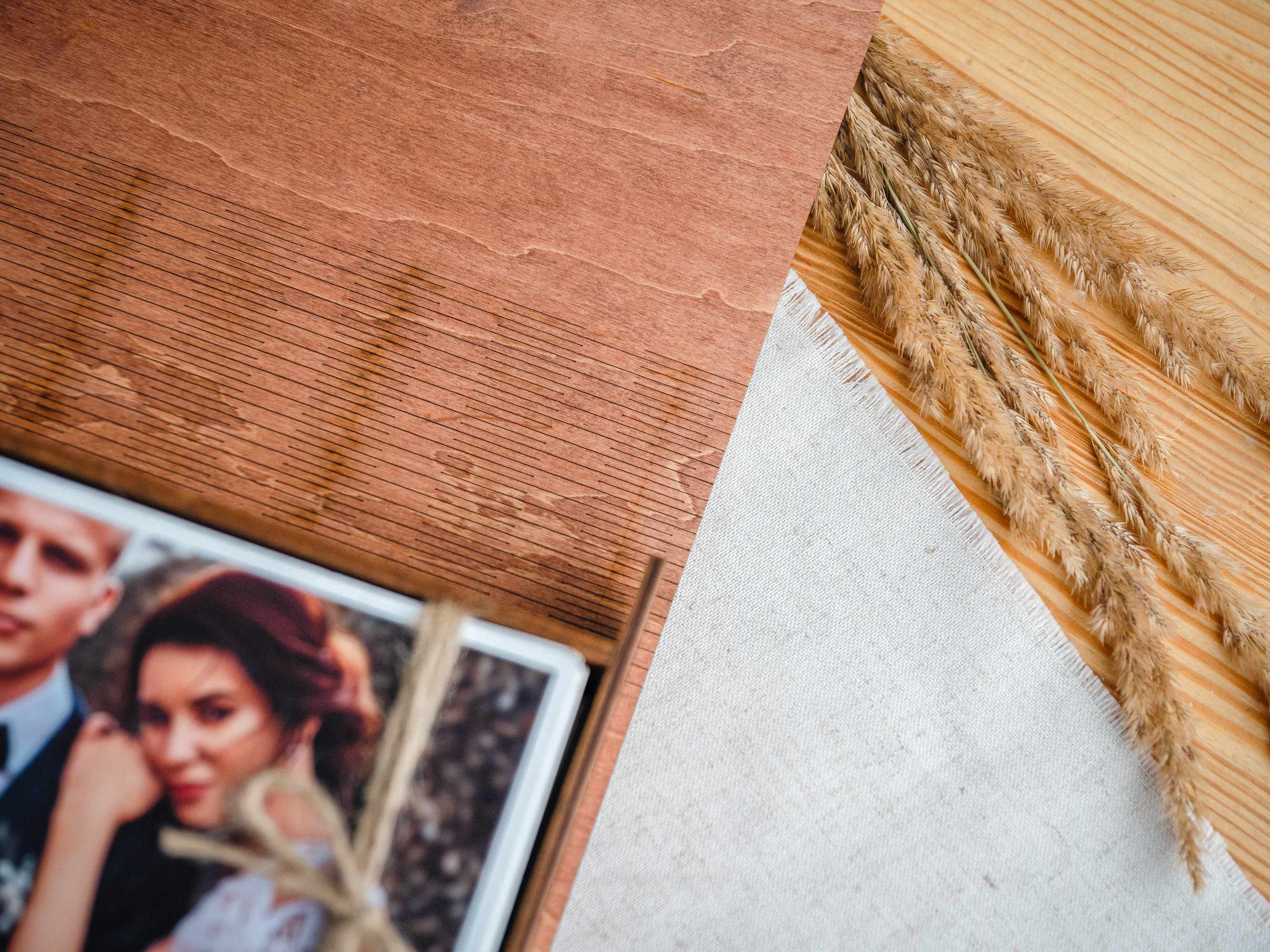 Teak photo box corner detail with wood grain texture and printed photo edge