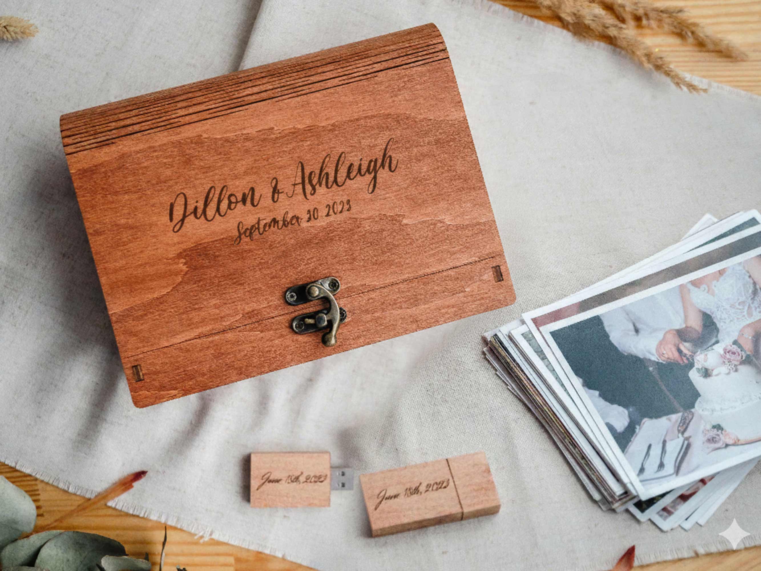 Teak wedding photo box with matching wooden USB and stack of prints on linen backdrop