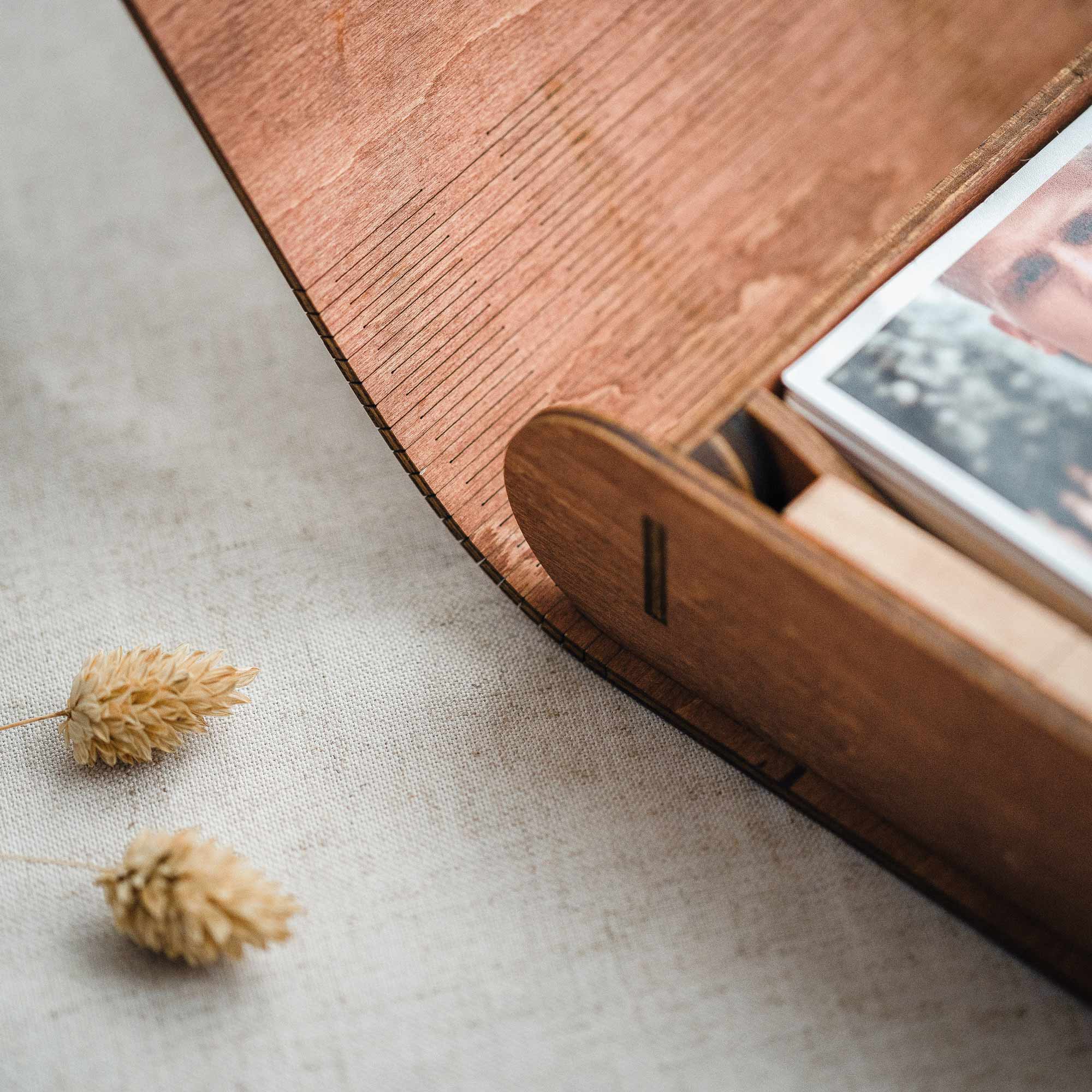 Teak photo box side detail showing rounded edge and photo stack inside