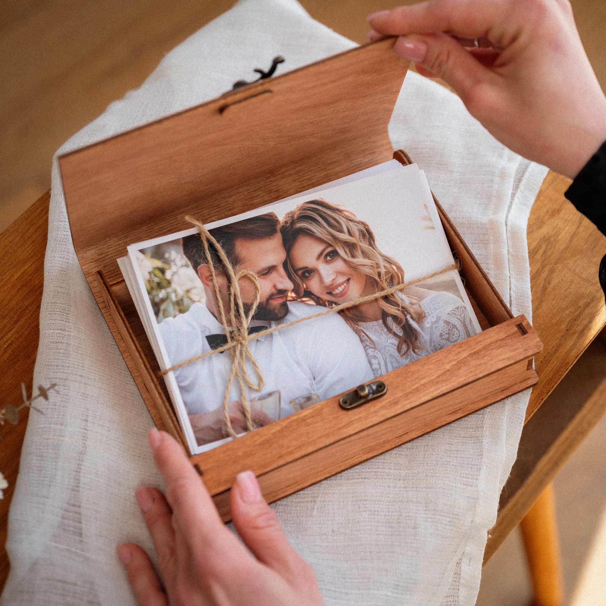 Teak photo box opening with prints