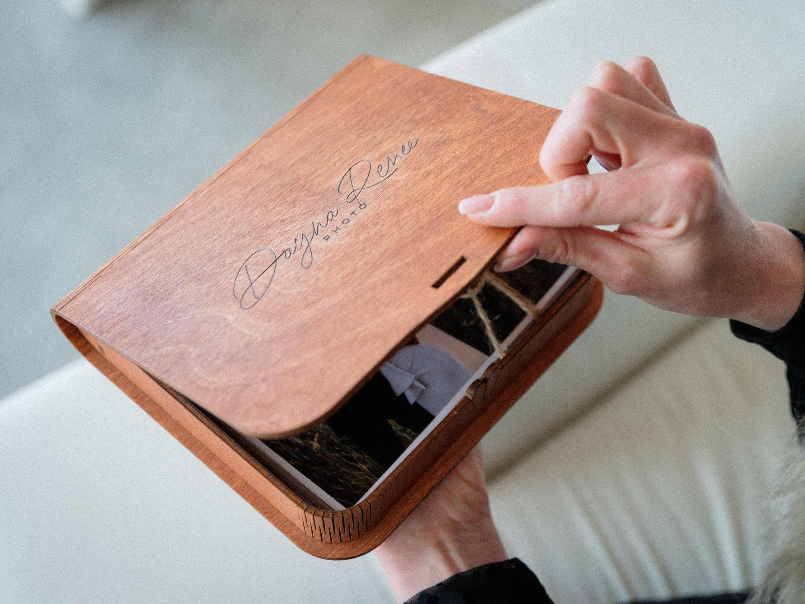 Close view of hand opening engraved teak wooden photo box