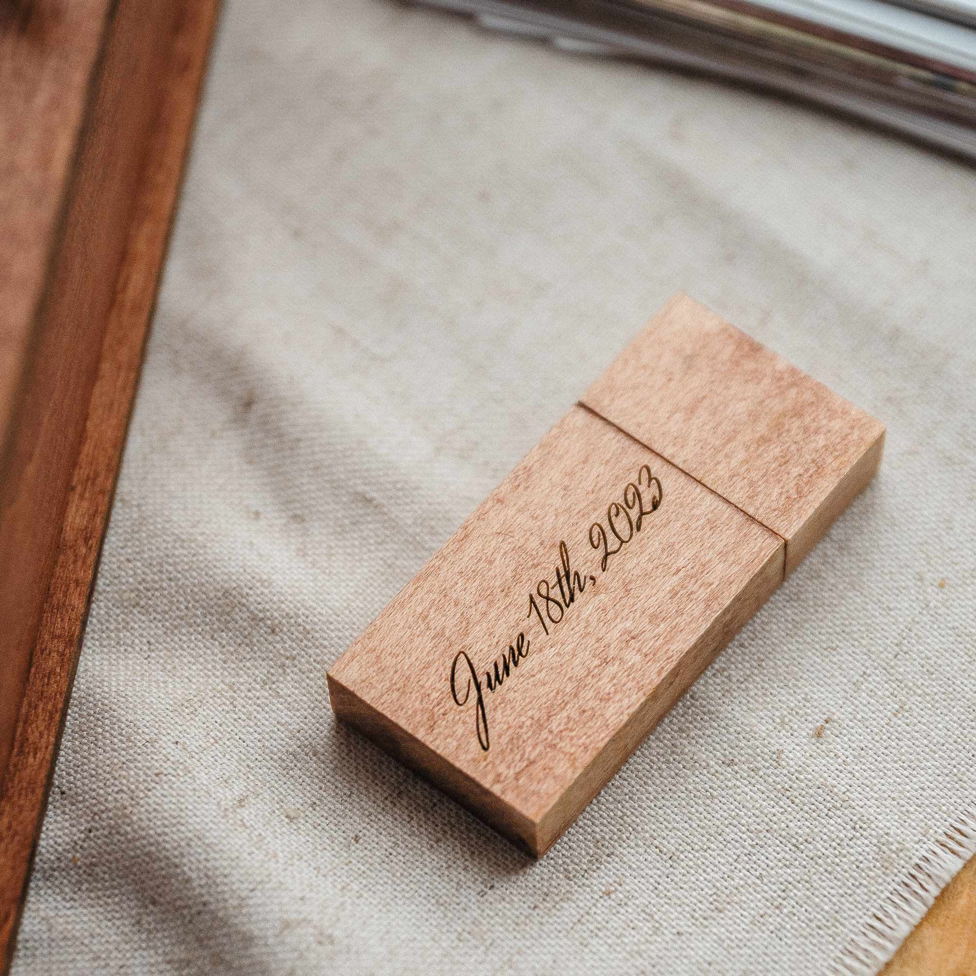 Engraved wooden USB 3.0 flash drive on neutral fabric background