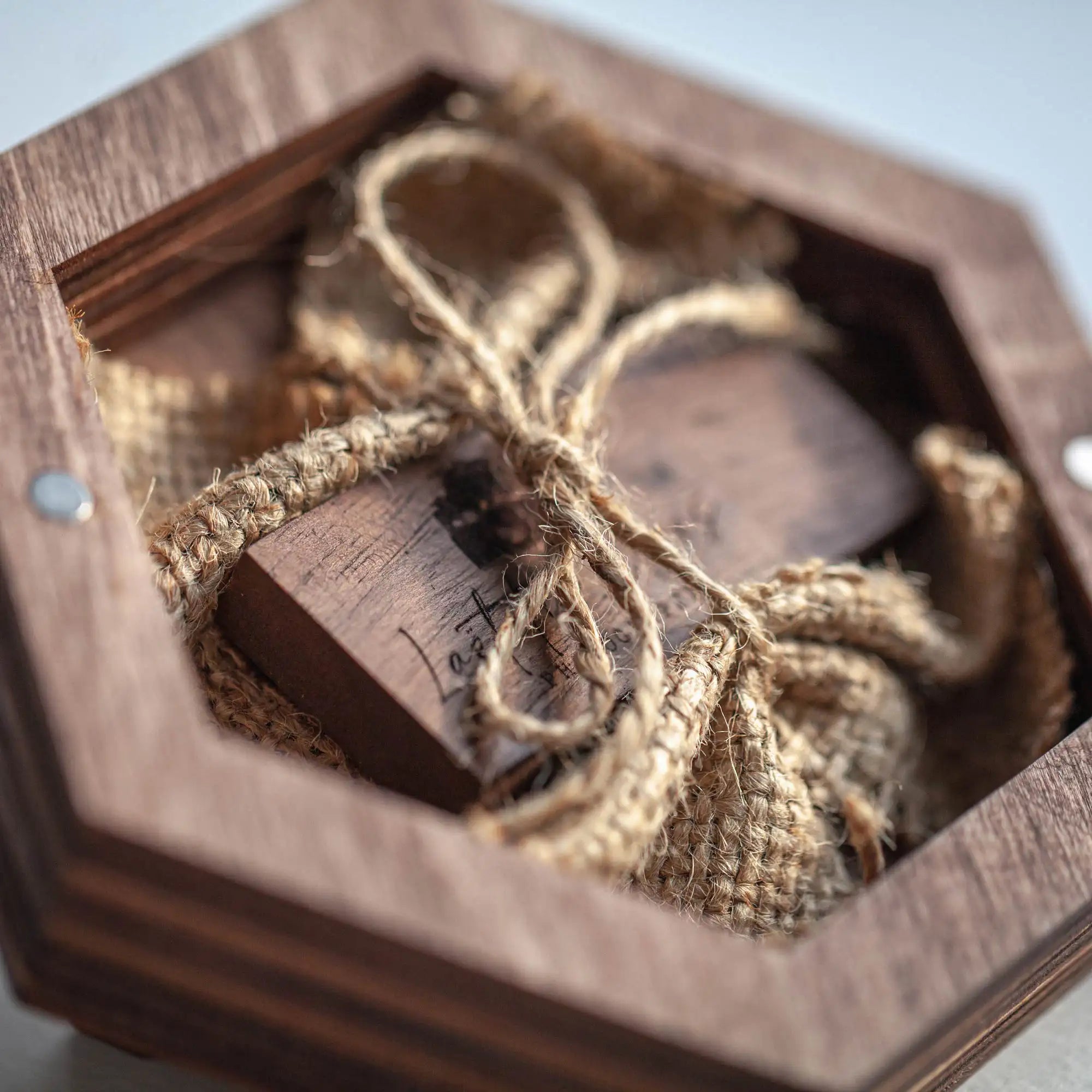 Open walnut wooden USB box with flash drive and natural flax filling