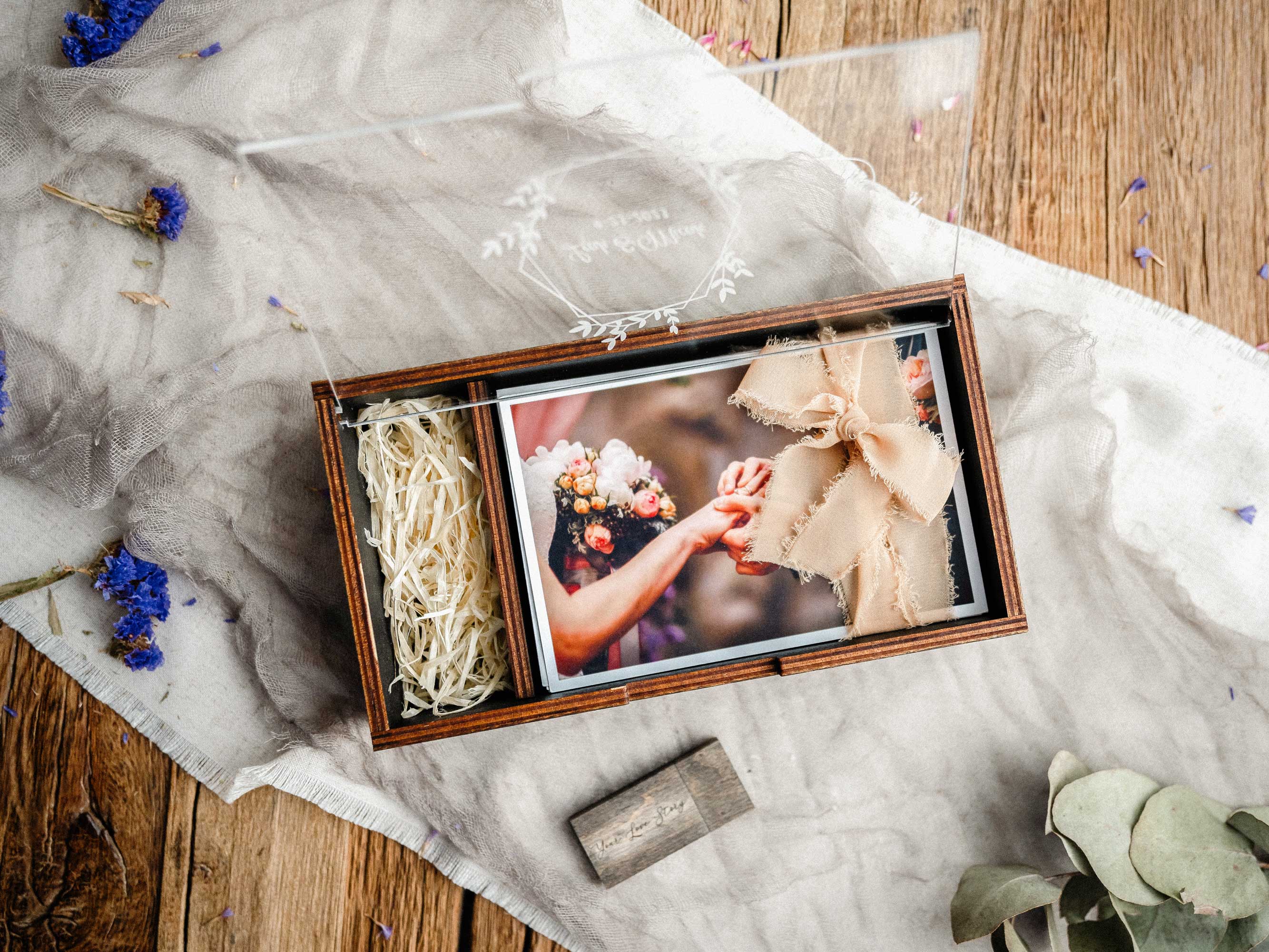 Black wedding photo box with acrylic lid and printed wedding photos flat lay