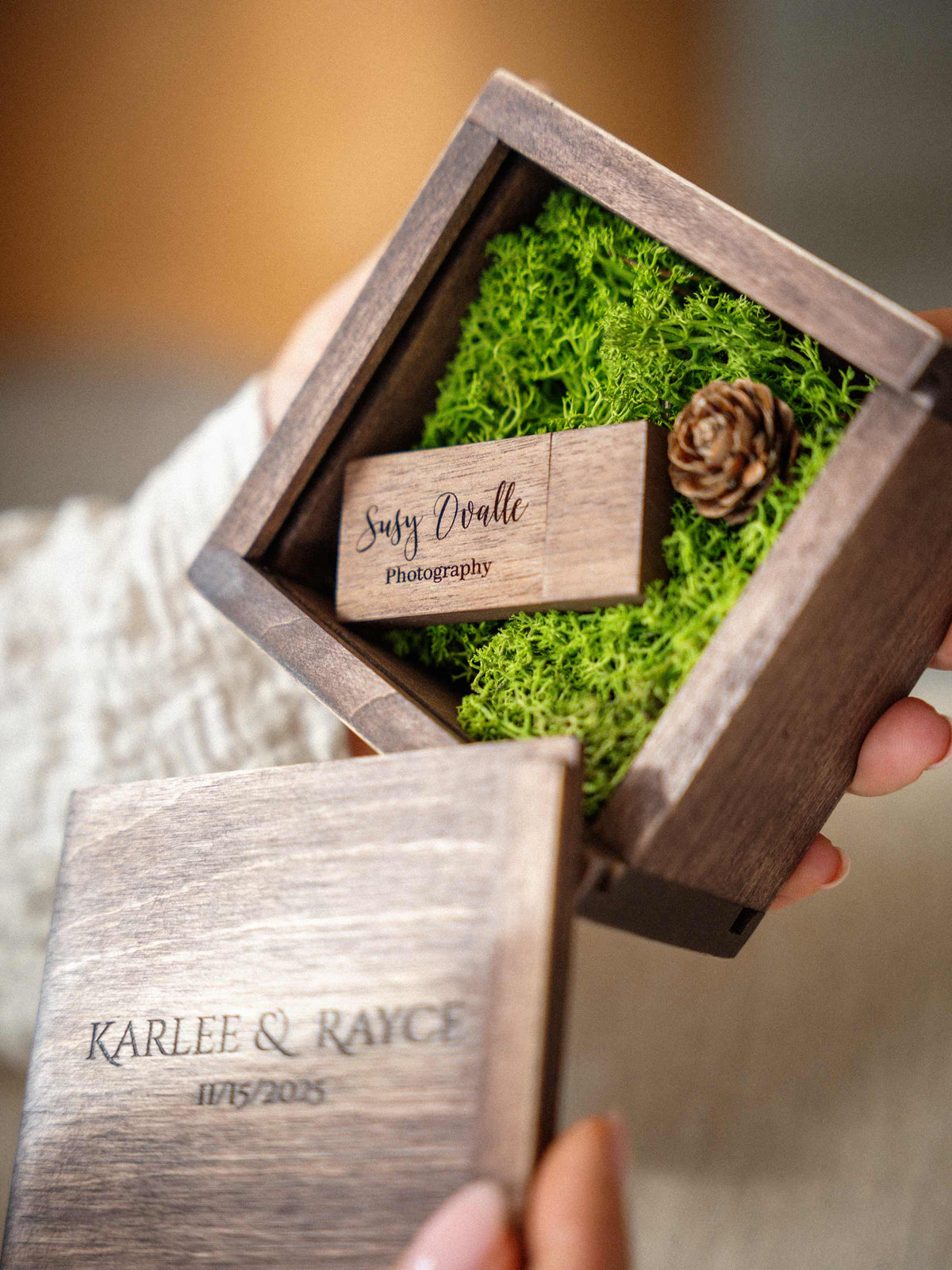 Open wooden USB box with custom engraved flash drive inside green moss and personalized sliding lid.