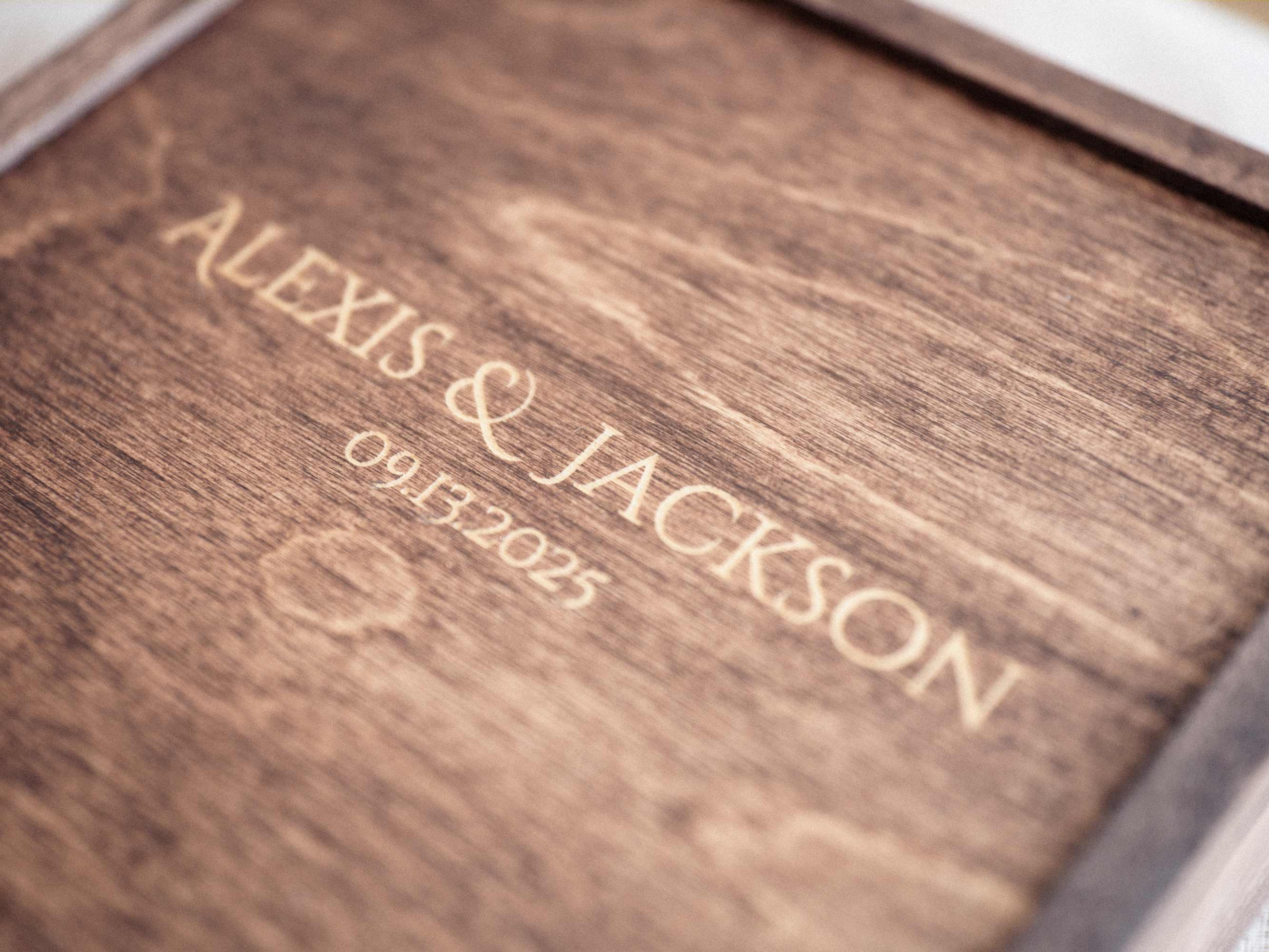 Close up of engraved Walnut Classic photo box with names and wedding date