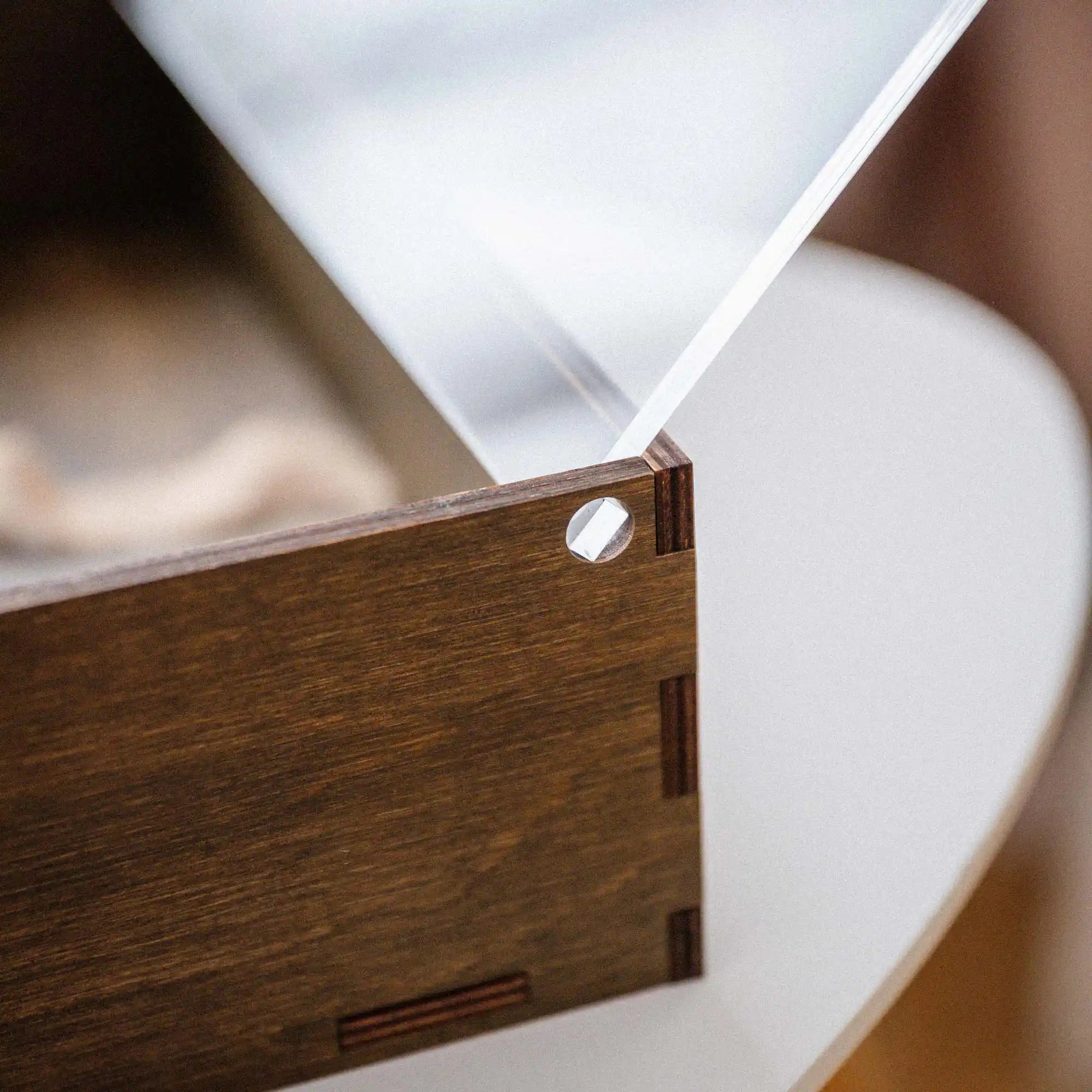 Corner detail of walnut wedding album box with hinged acrylic lid