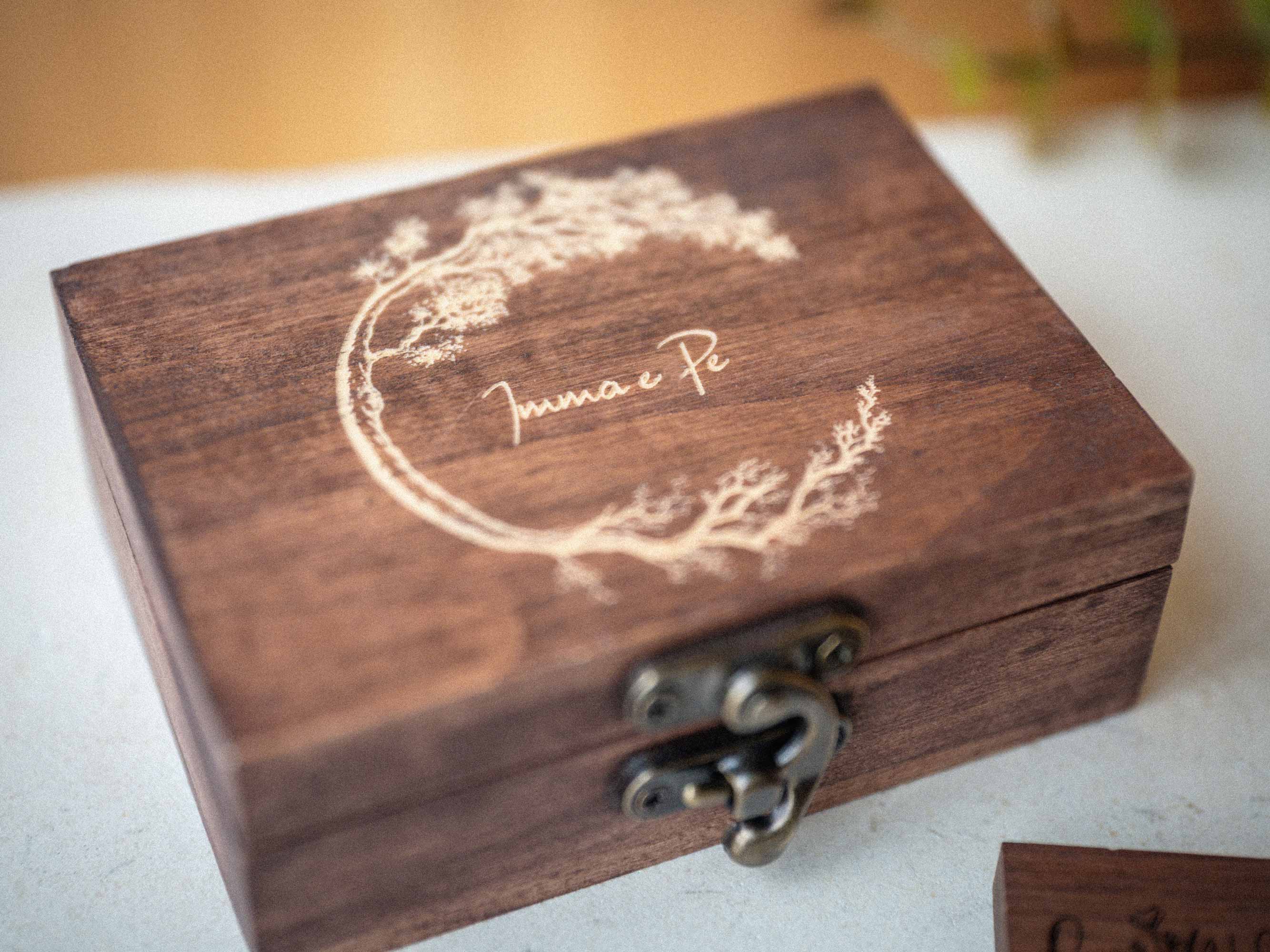 Walnut wooden USB box with light engraved lid on warm background